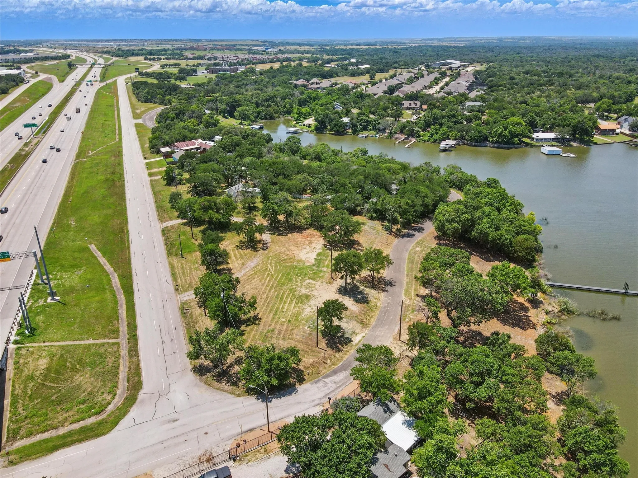 View of property location with a major roadway and a large body of water