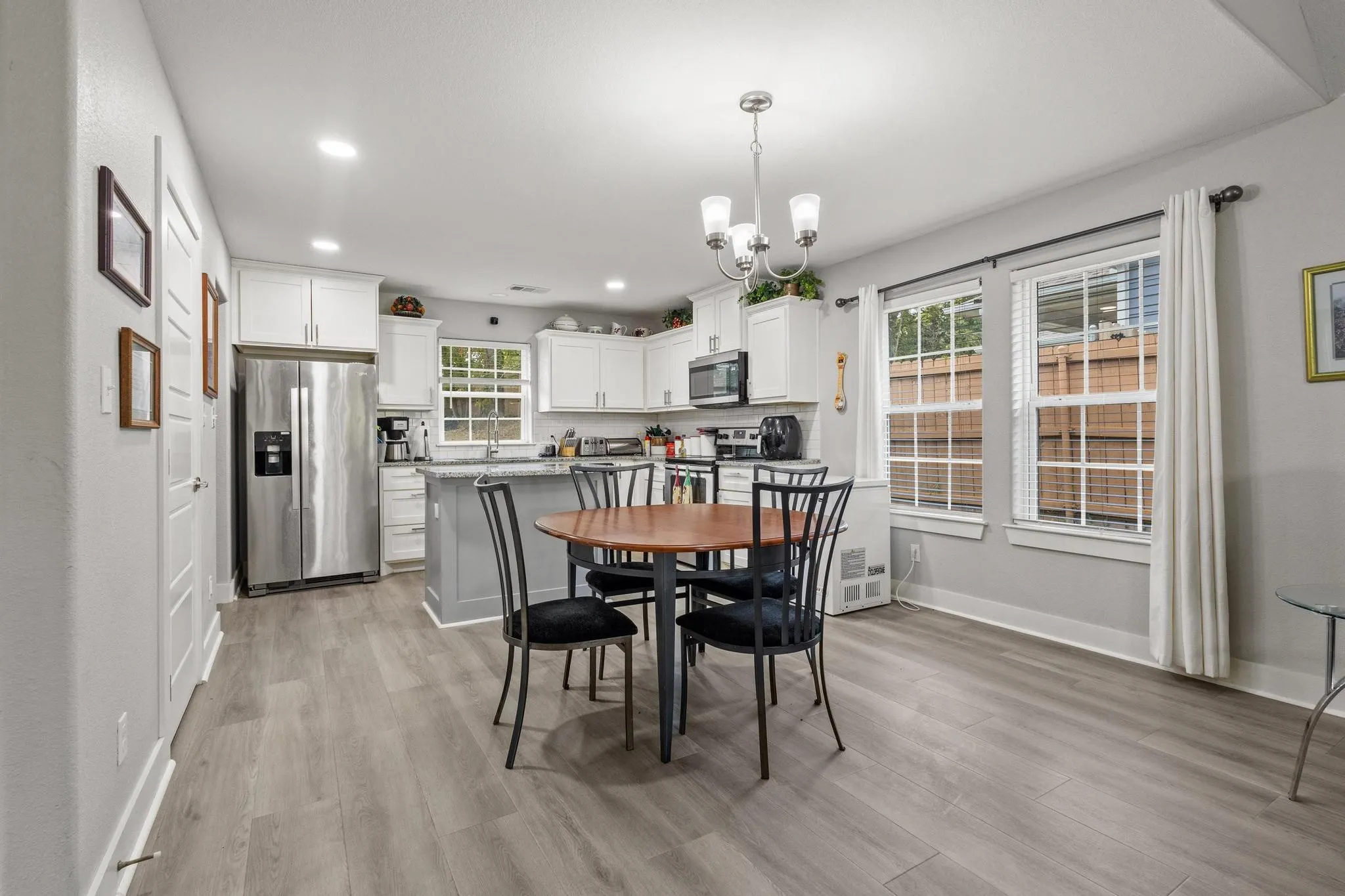 Open-concept room featuring wood-finish flooring and light gray walls