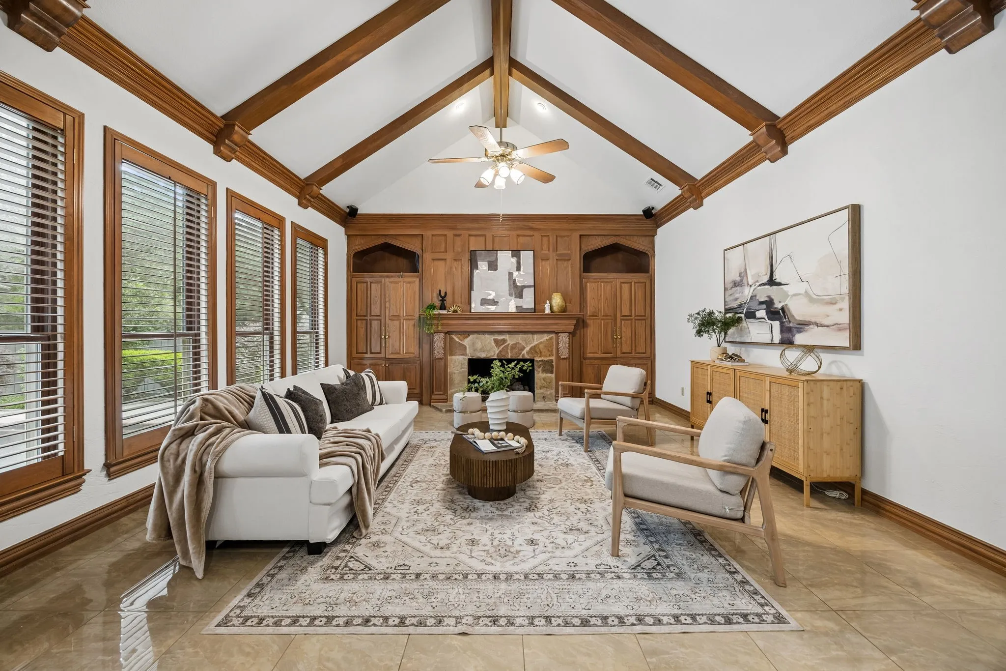 Vaulted ceiling with wood beams and ceiling fan