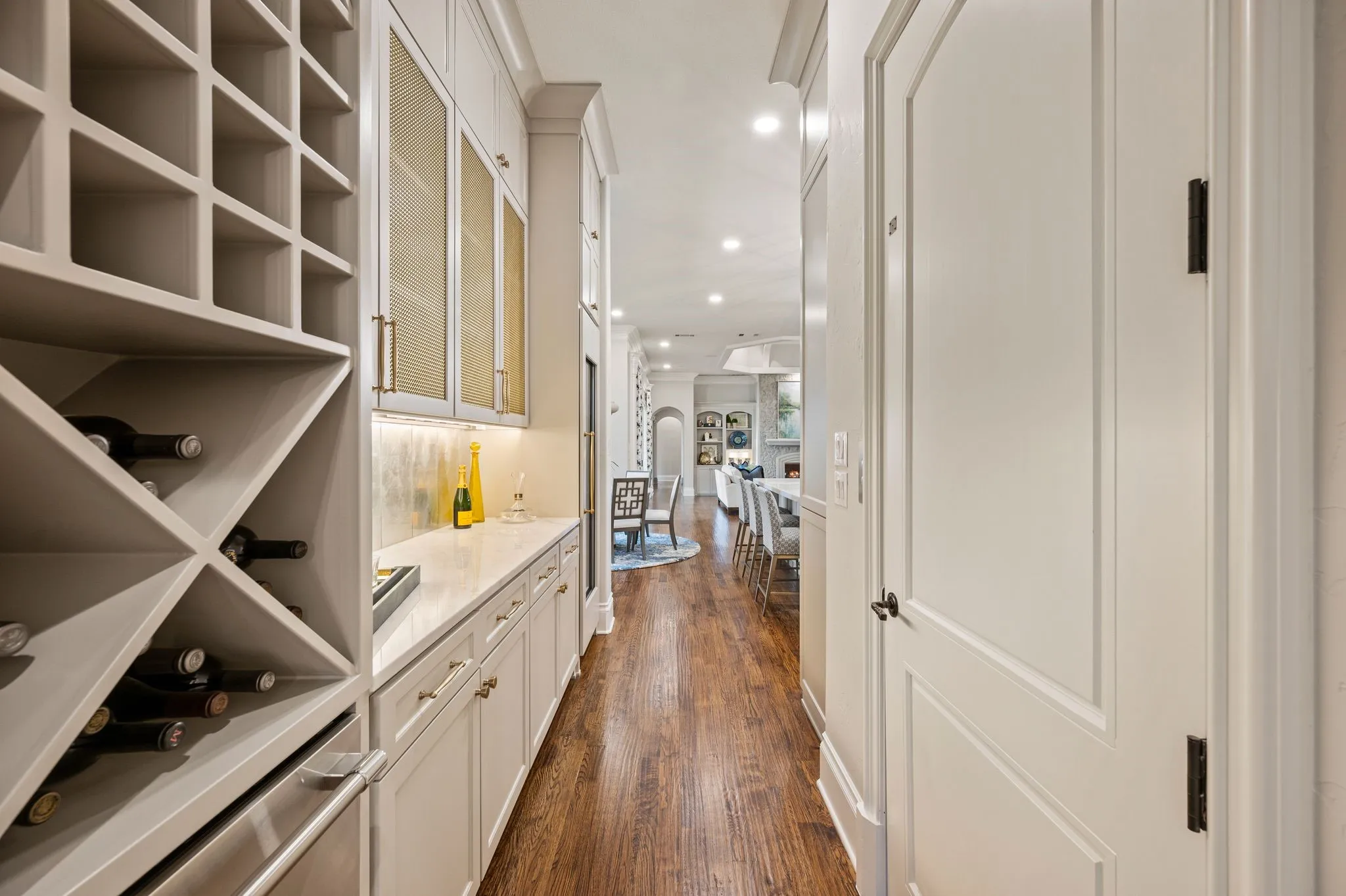 The butlery between the formal dining room & kitchen features beverage drawers, wine storage bins & a tall Thermador wine refrigerator.