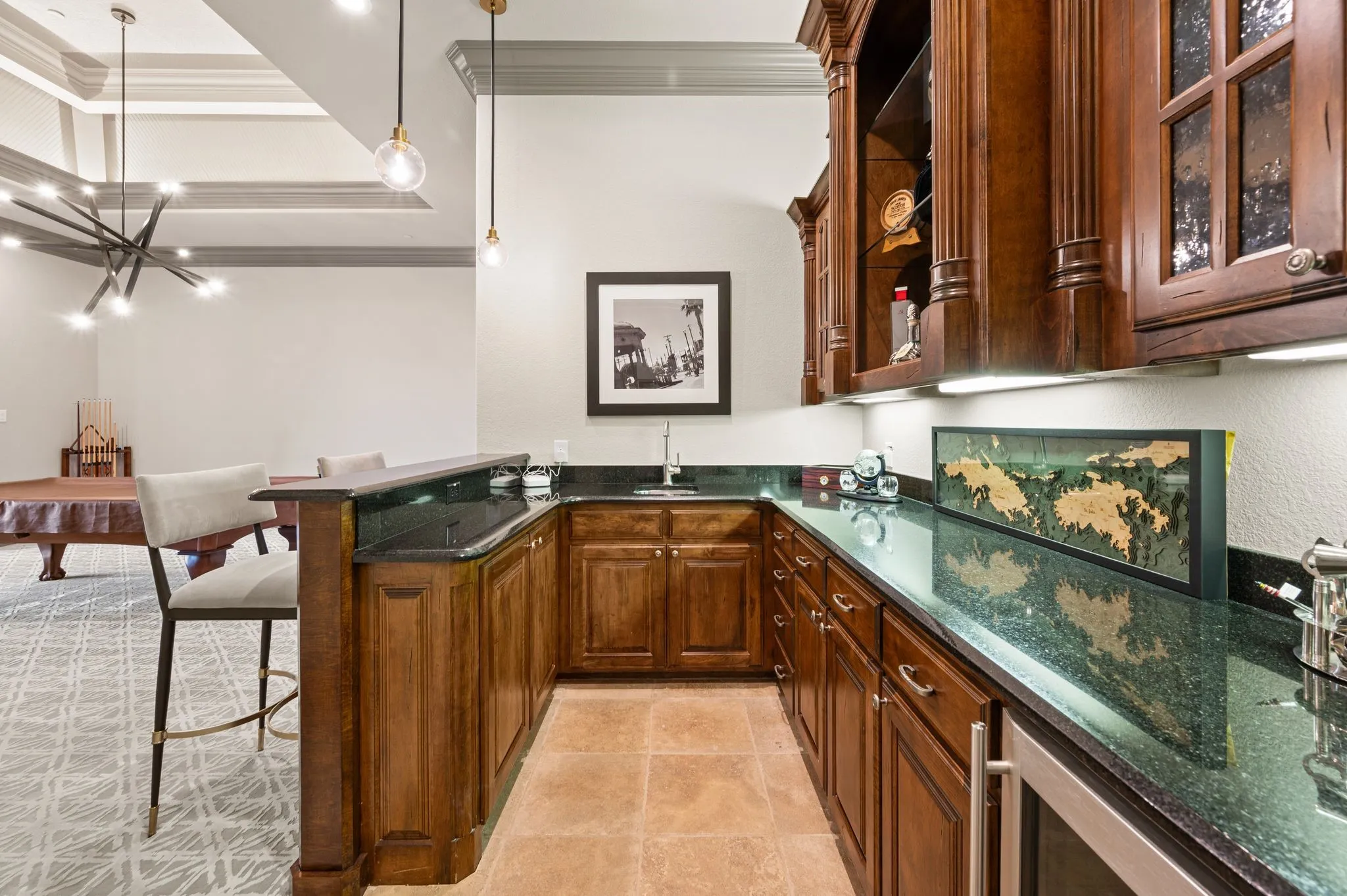 Wet bar connects the first-floor billiard room & media room.