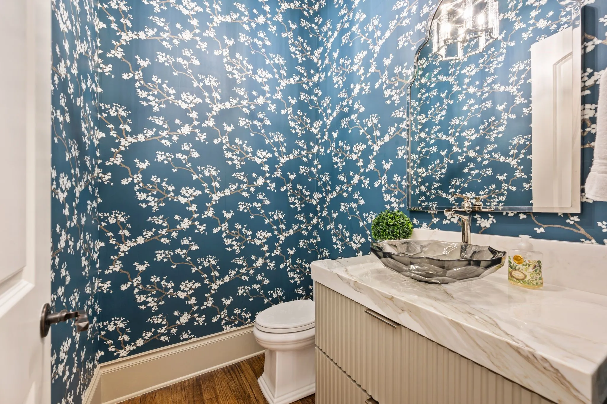 This beautifully decorated half bath is located on the main level.