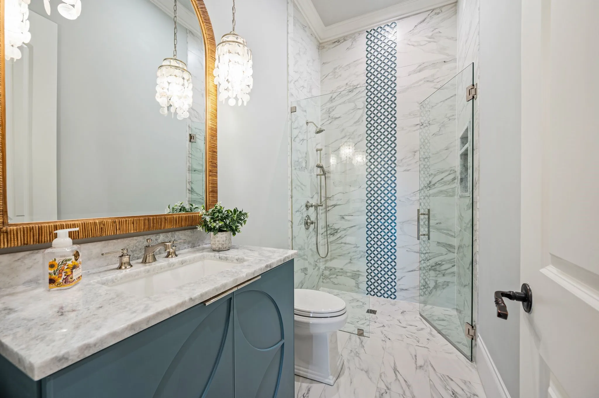 Full bath on main level. Note the inspired tile work in the shower & the detailed vanity trim work.