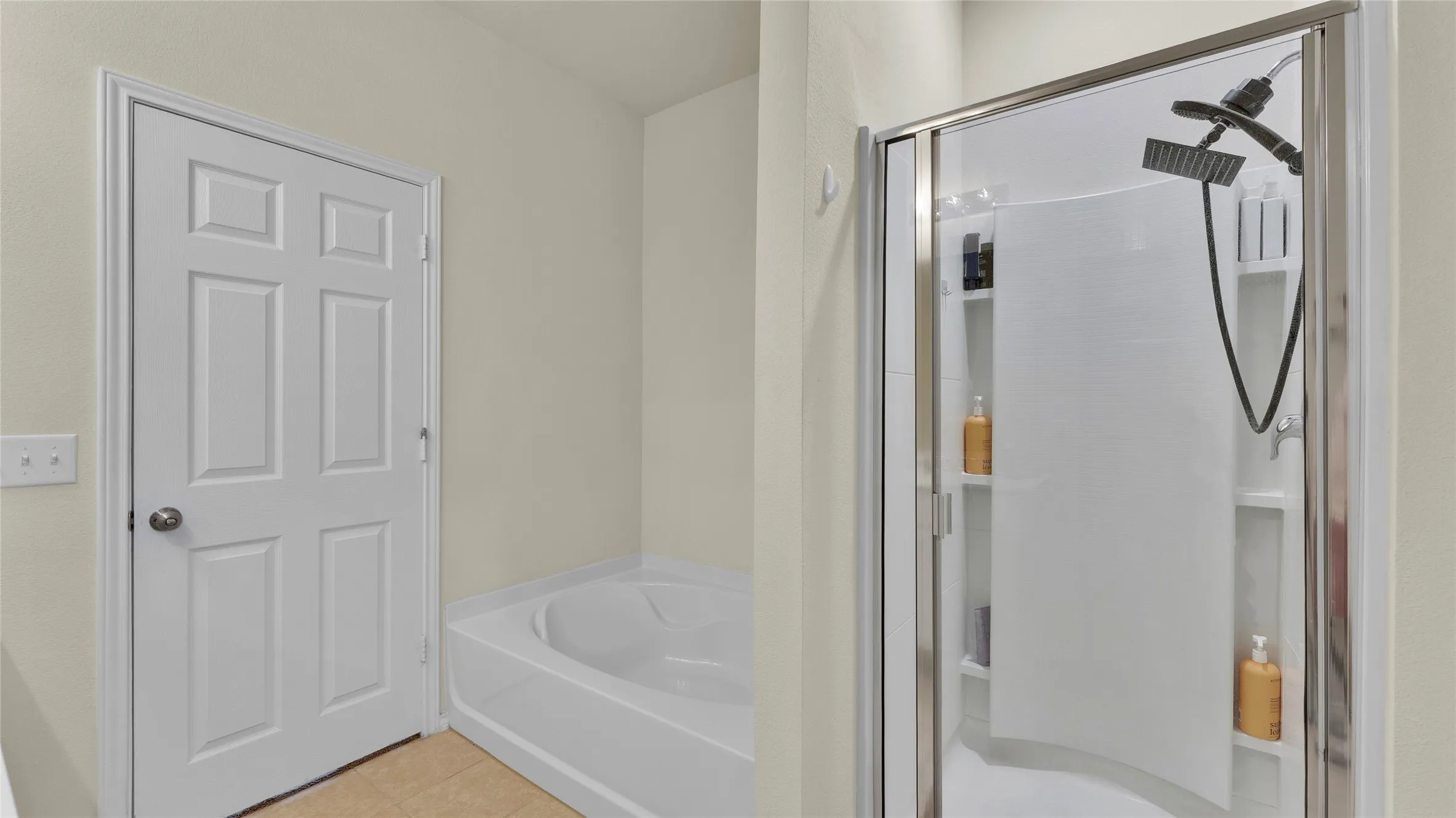 Bathroom featuring a soaking tub, a multi-function shower with a glass enclosure, built-in shower shelving, and a six-panel interior door