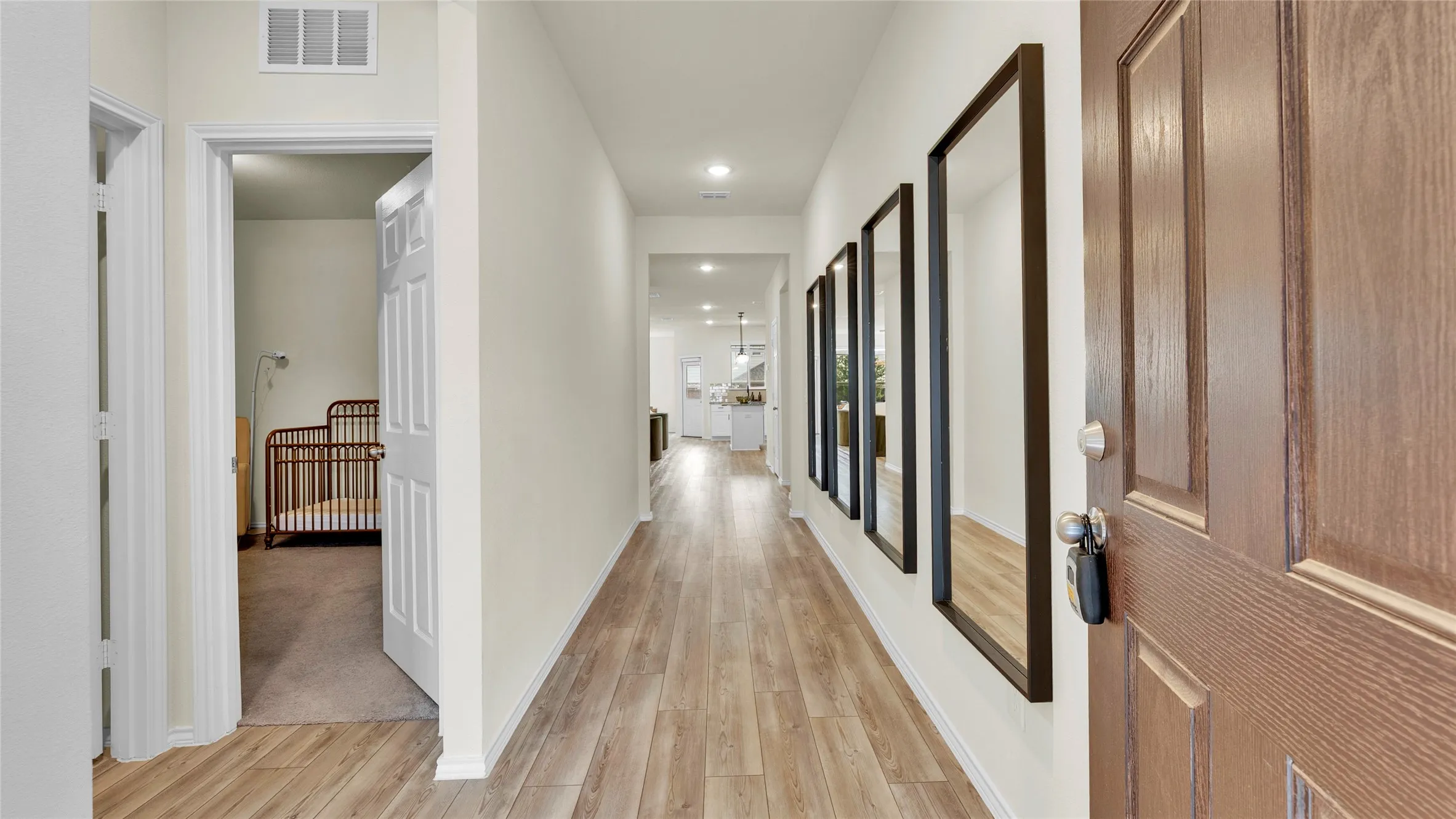 Entryway featuring wood-finish flooring, recessed lighting, and a paneled wooden door