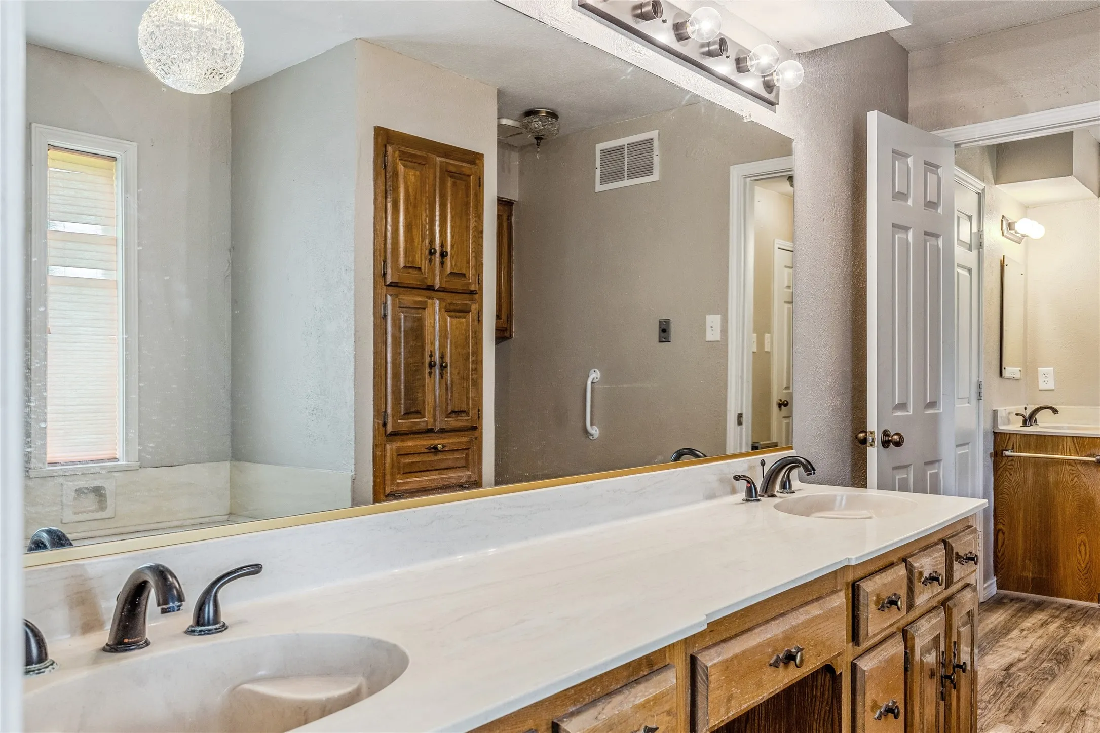 Double vanity with white countertop and integrated sinks