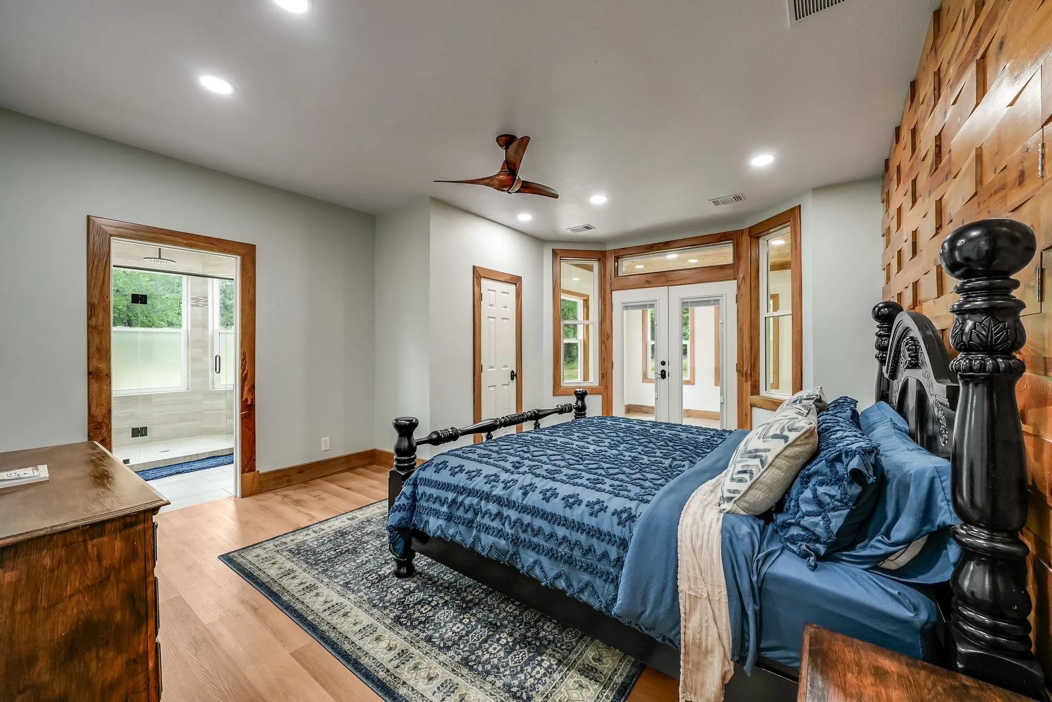 Main Bedroom #1 on first floor featuring wood-finish flooring, recessed lighting, and a wood accent wall