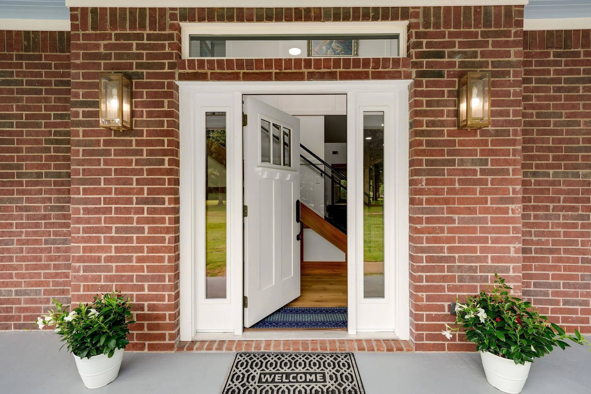 Brick facade with white trim surrounding the entryway
