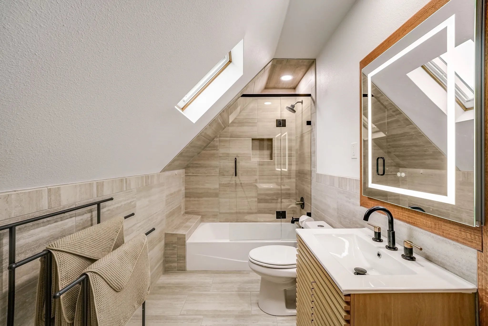 Ensuite Full Bathroom#2 (Sits off of Room #3) featuring a skylight, tile flooring, and a walk-in shower with glass enclosure