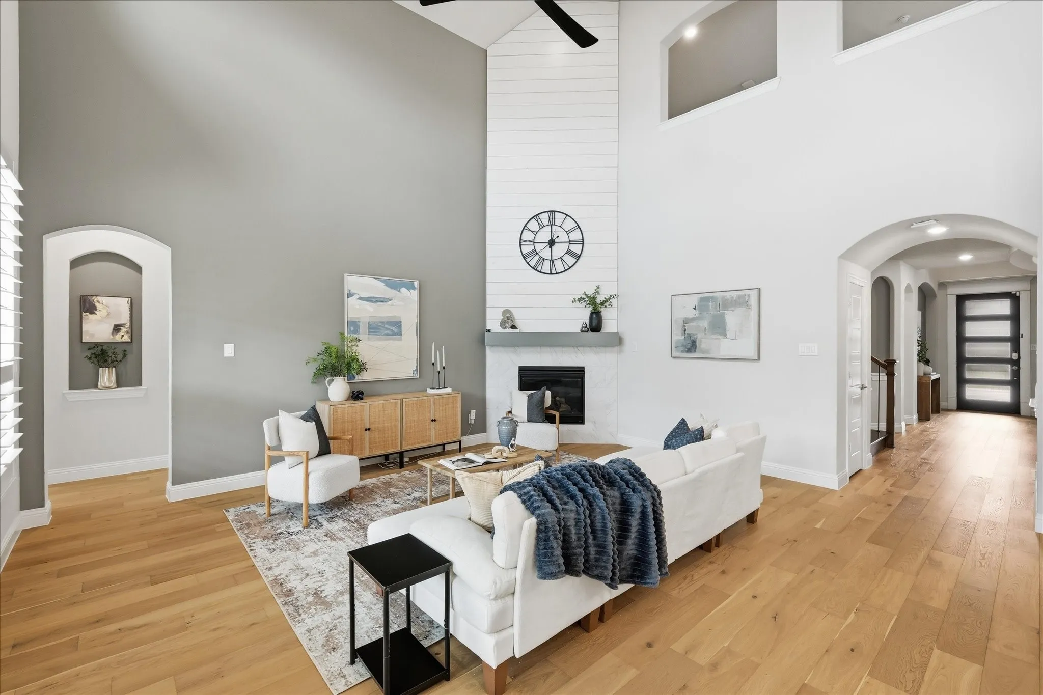Double height ceilings, blonde hard wood flooring.
