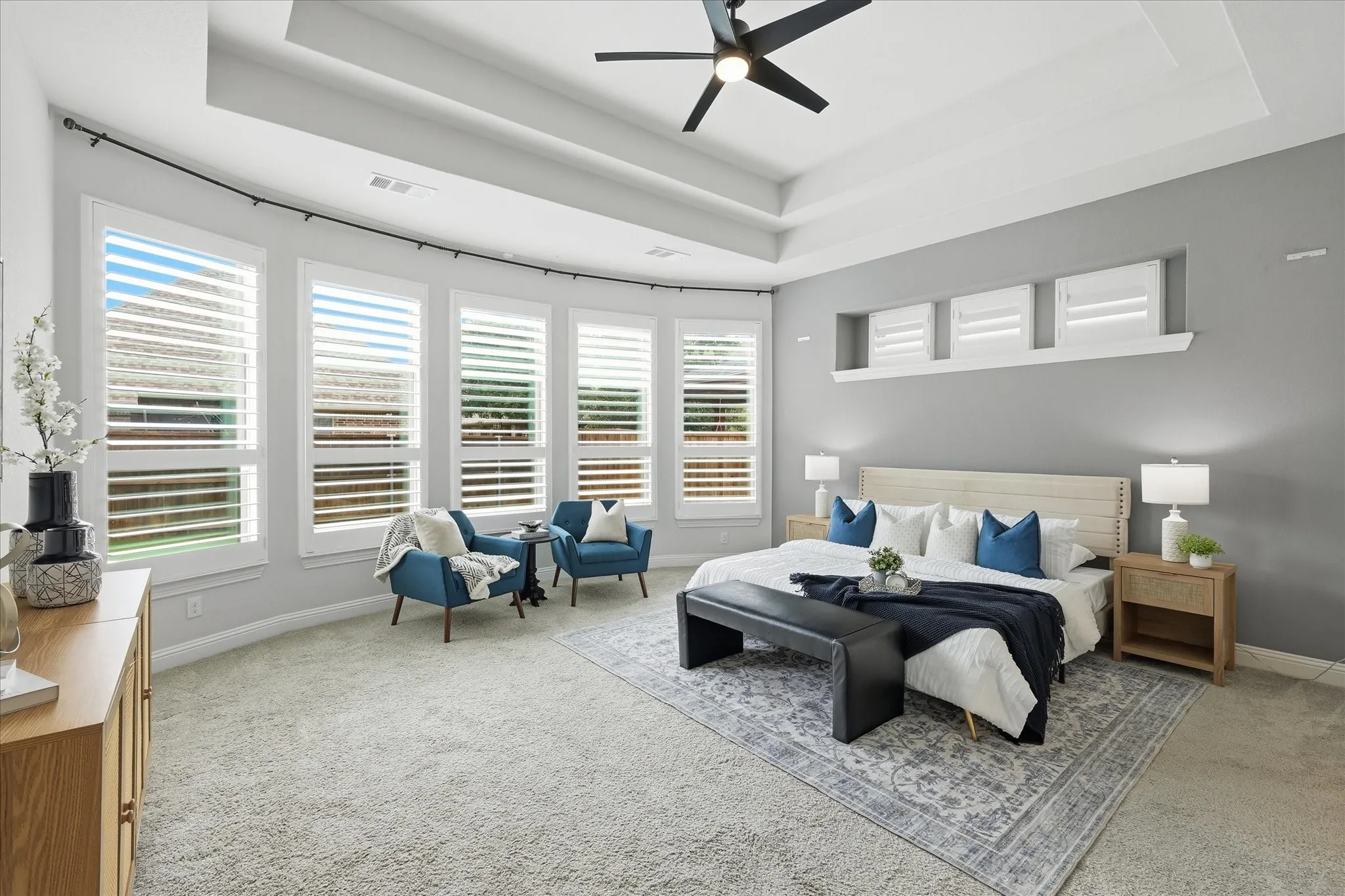 Bowed windows and tray ceilings in super large primary bedroom