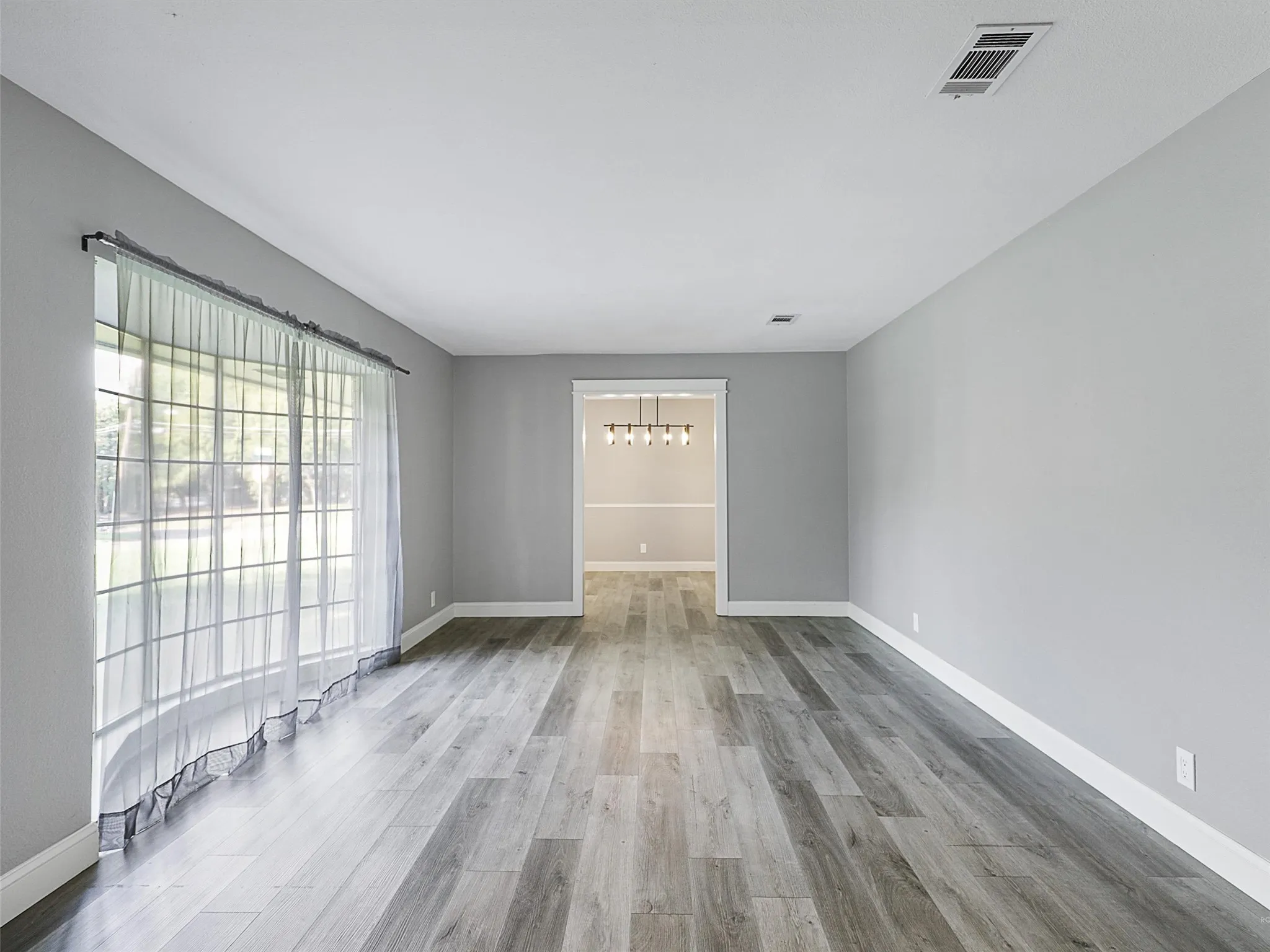 Expansive secondary living area offering endless possibilities for gathering, relaxing, or creating a personalized retreat.