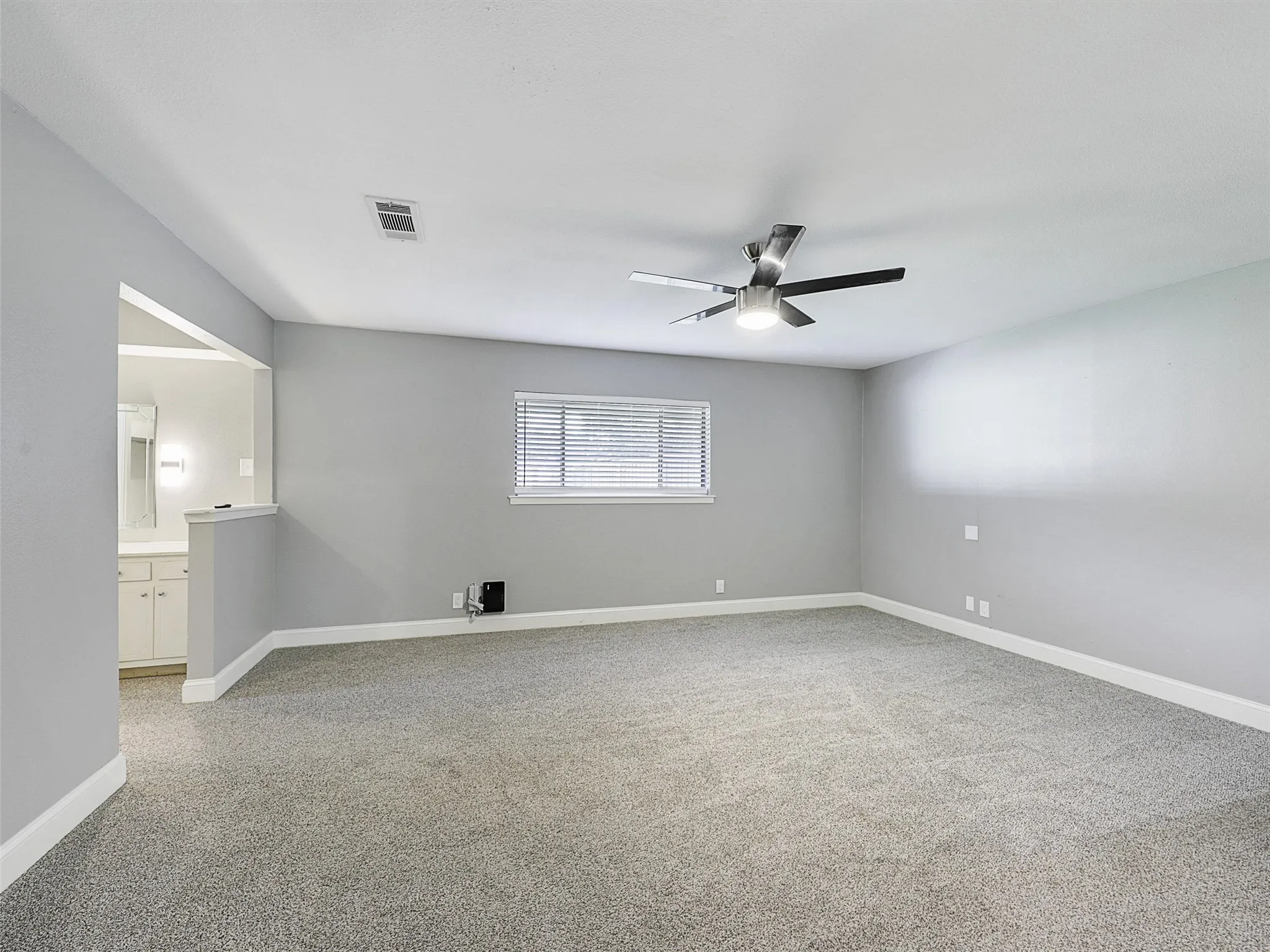 Oversized primary retreat offering plenty of space for a sitting area, workspace, or private escape.