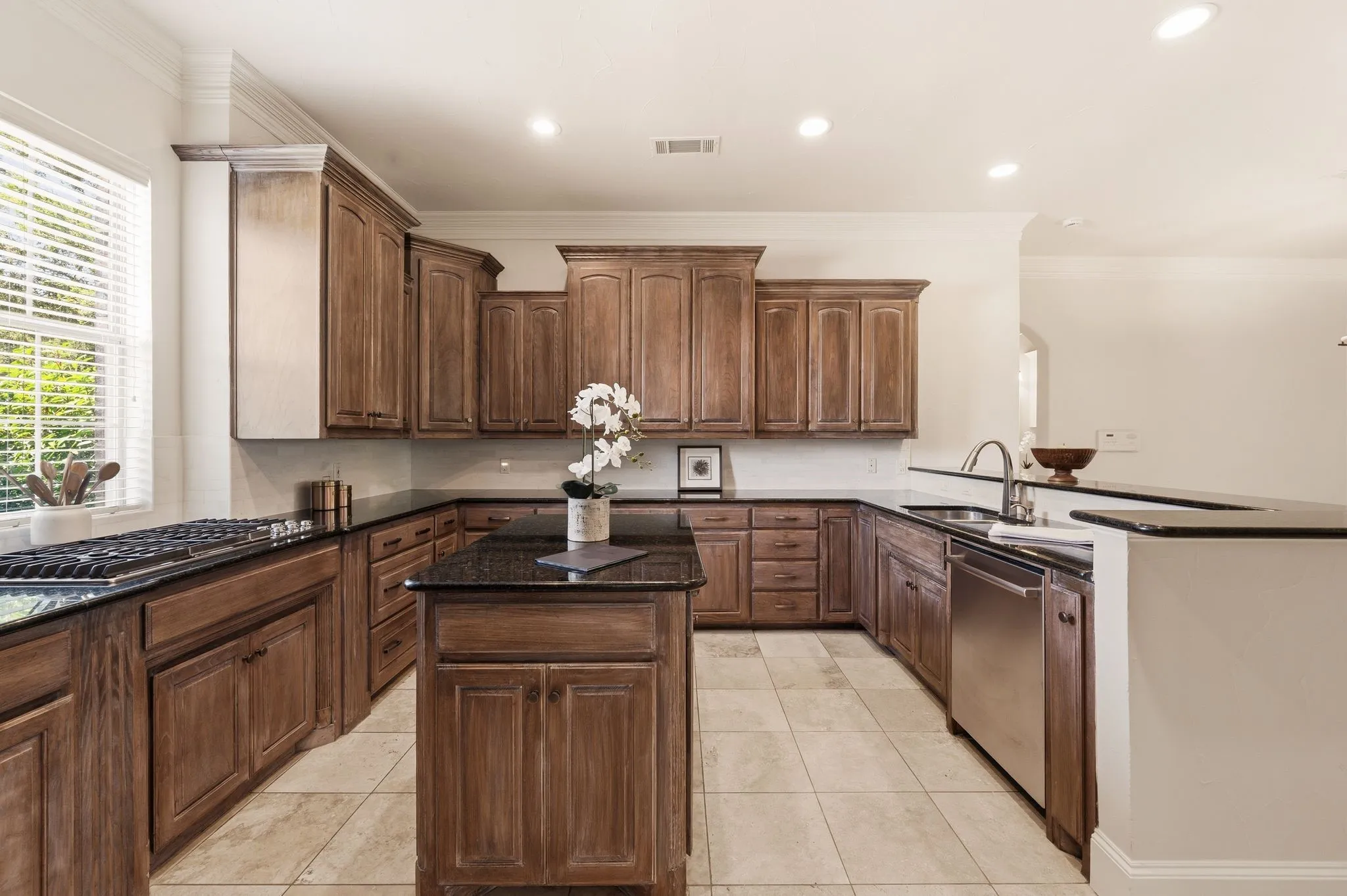 Island kitchen has fine walnut cabinets, granite counters, white marble backsplash and new stainless appliances