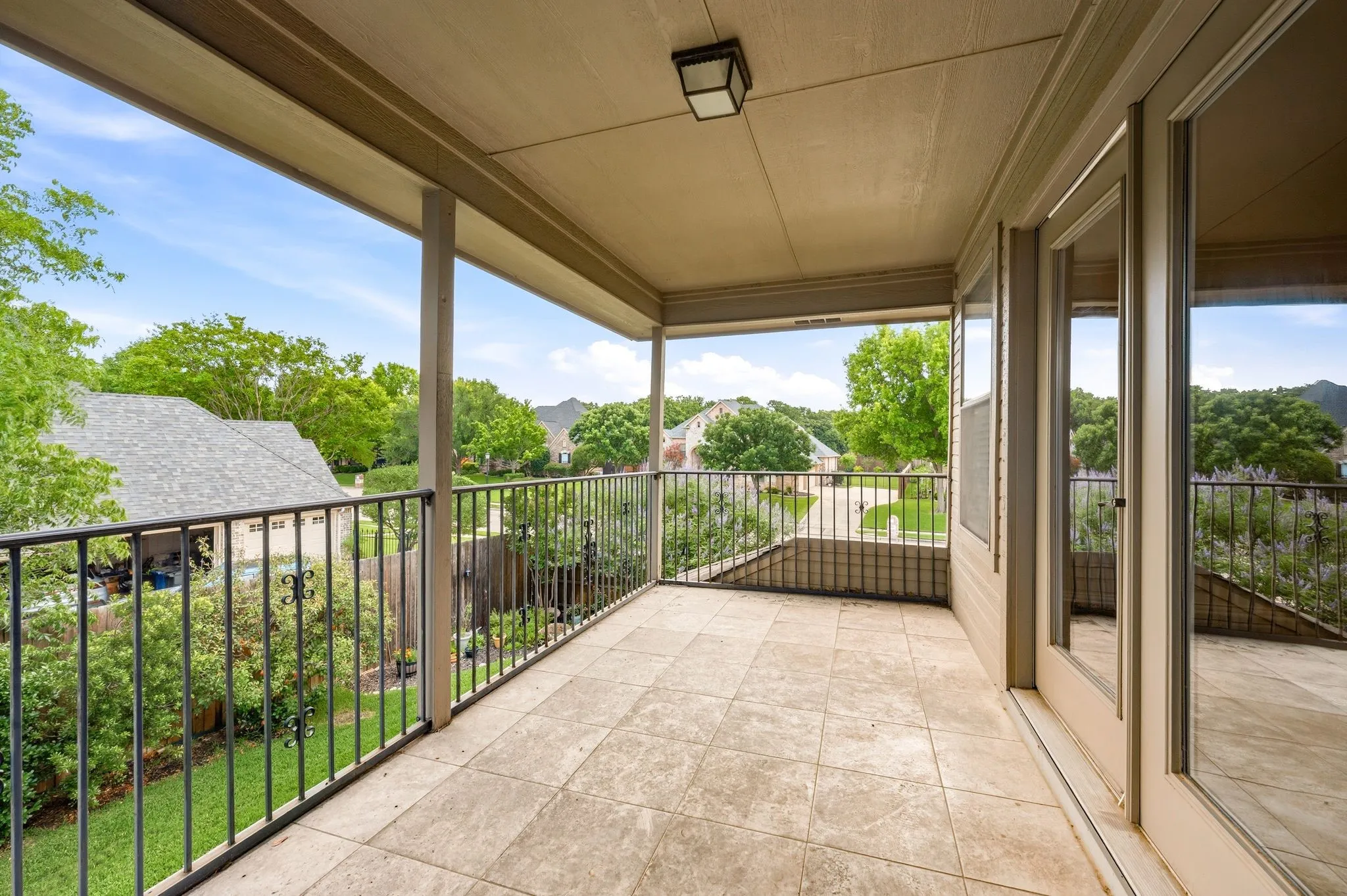 Balcony extends the gameroom/5th bedroom outside and overlooks backyard