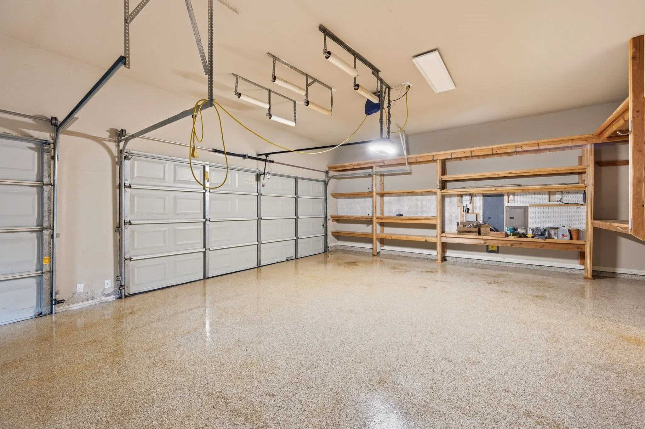 Three Car Garage has been customized with plenty of storage and a work area