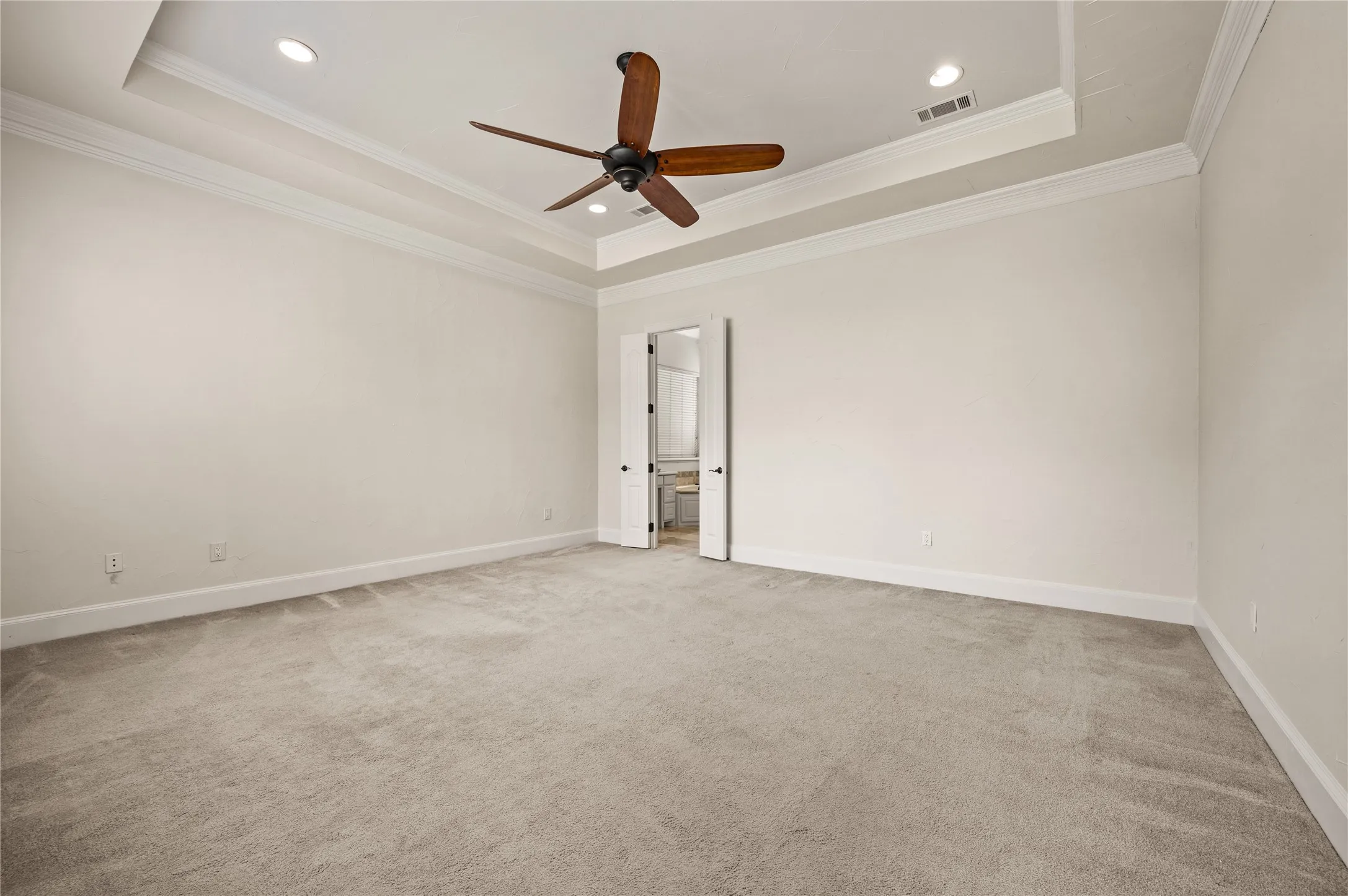 Primary Suite with ensuite bathroom and closet customized by Closets By Design