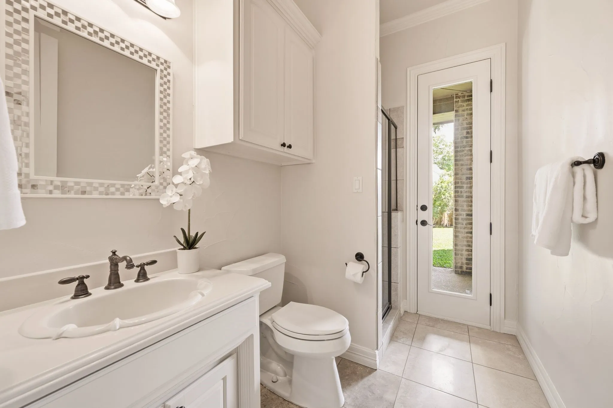 Second first floor bathroom has a convenient door to the backyard