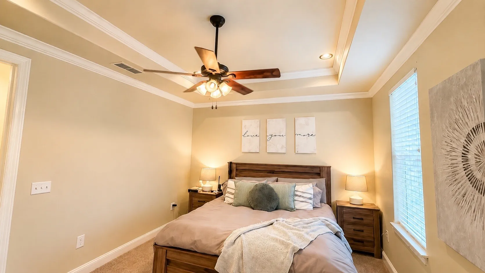 Bedroom featuring a tray ceiling with recessed lighting and a ceiling fan