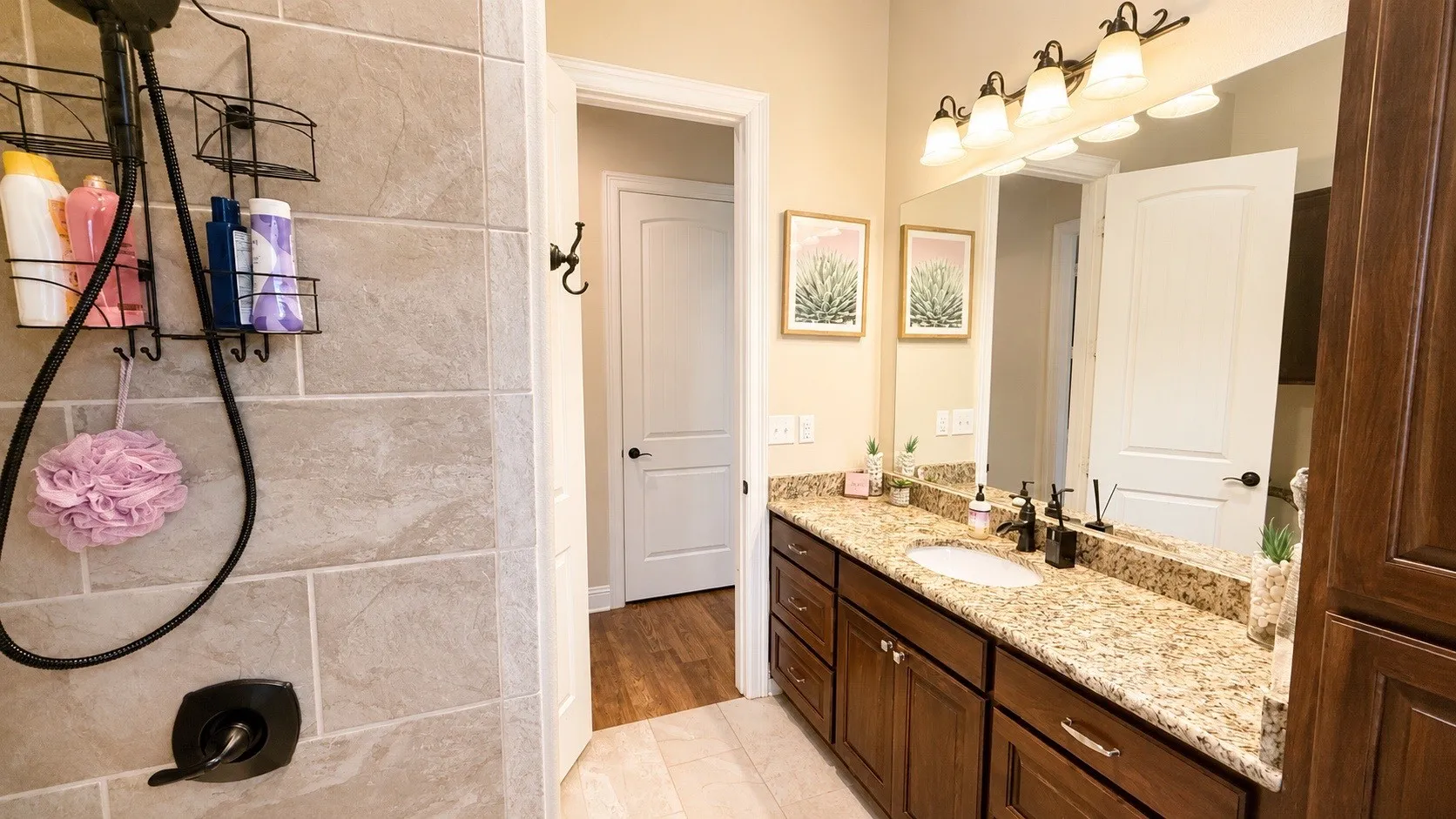 Bathroom vanity featuring an expansive stone countertop, undermount sink, and dark wood cabinetry