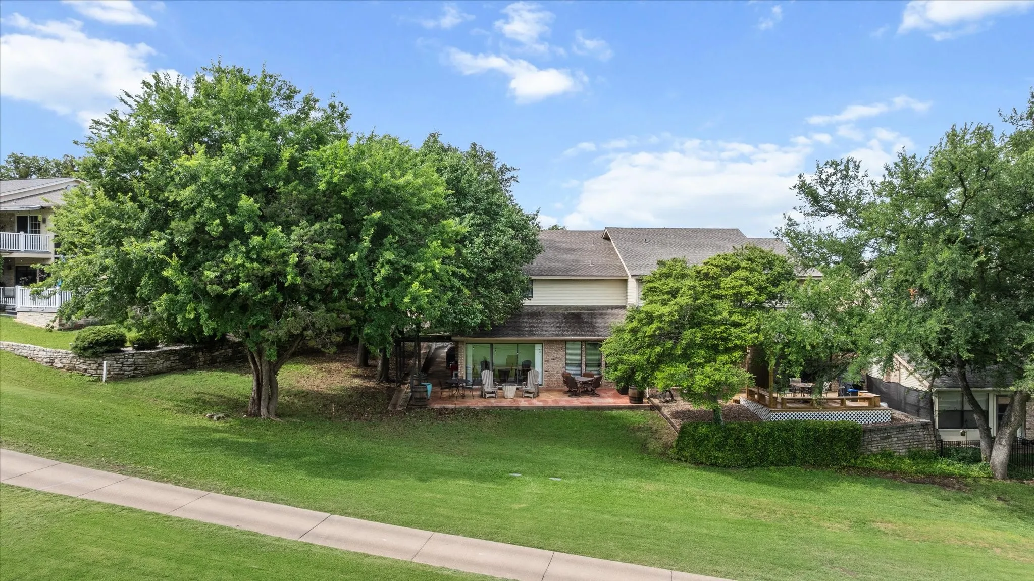 Backyard featuring a large patio, mature trees