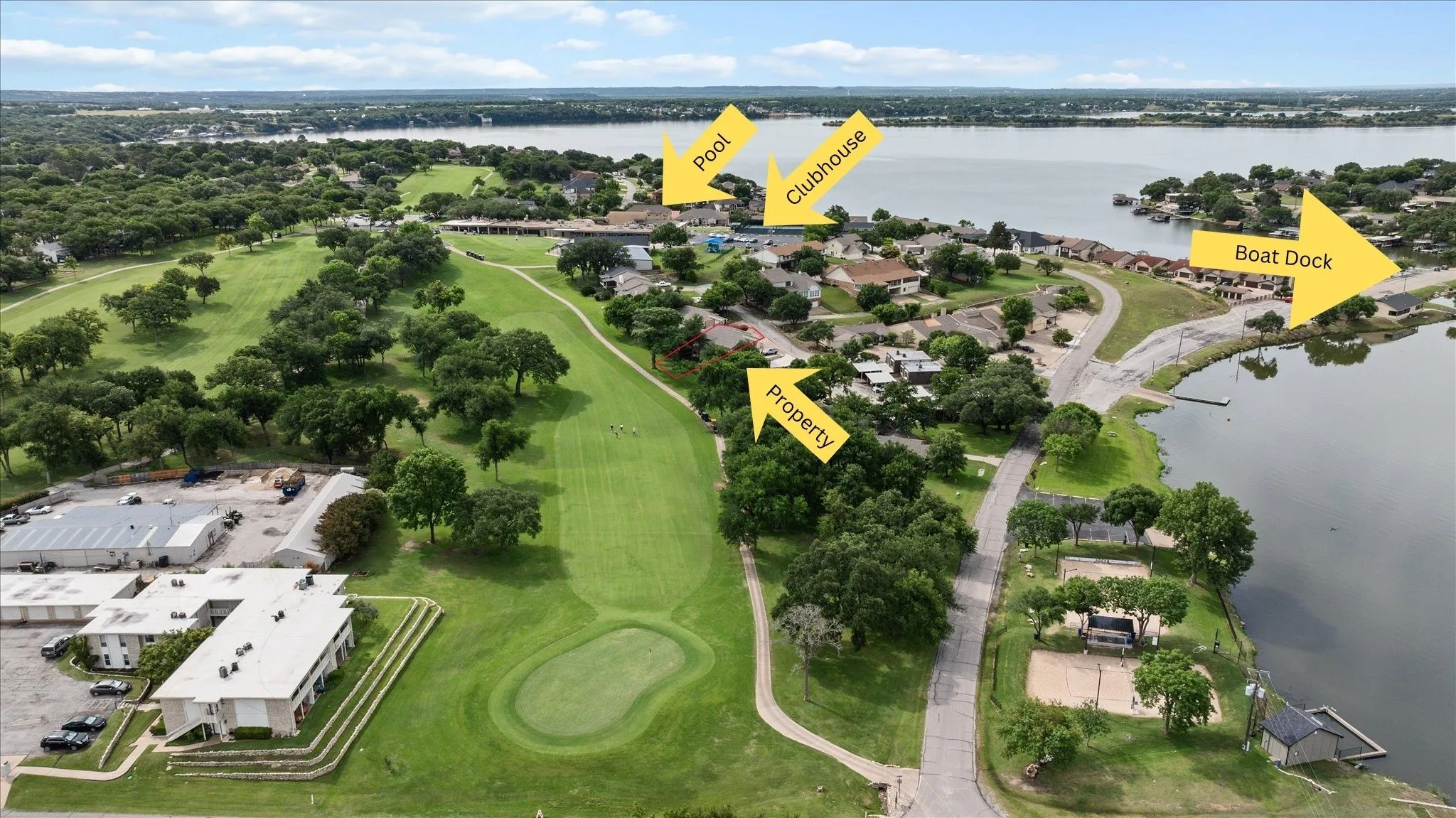 Aerial showcasing the property situated Lake Granbury featuring a golf course, clubhouse, and boat dock. Property Lines are Approximate
