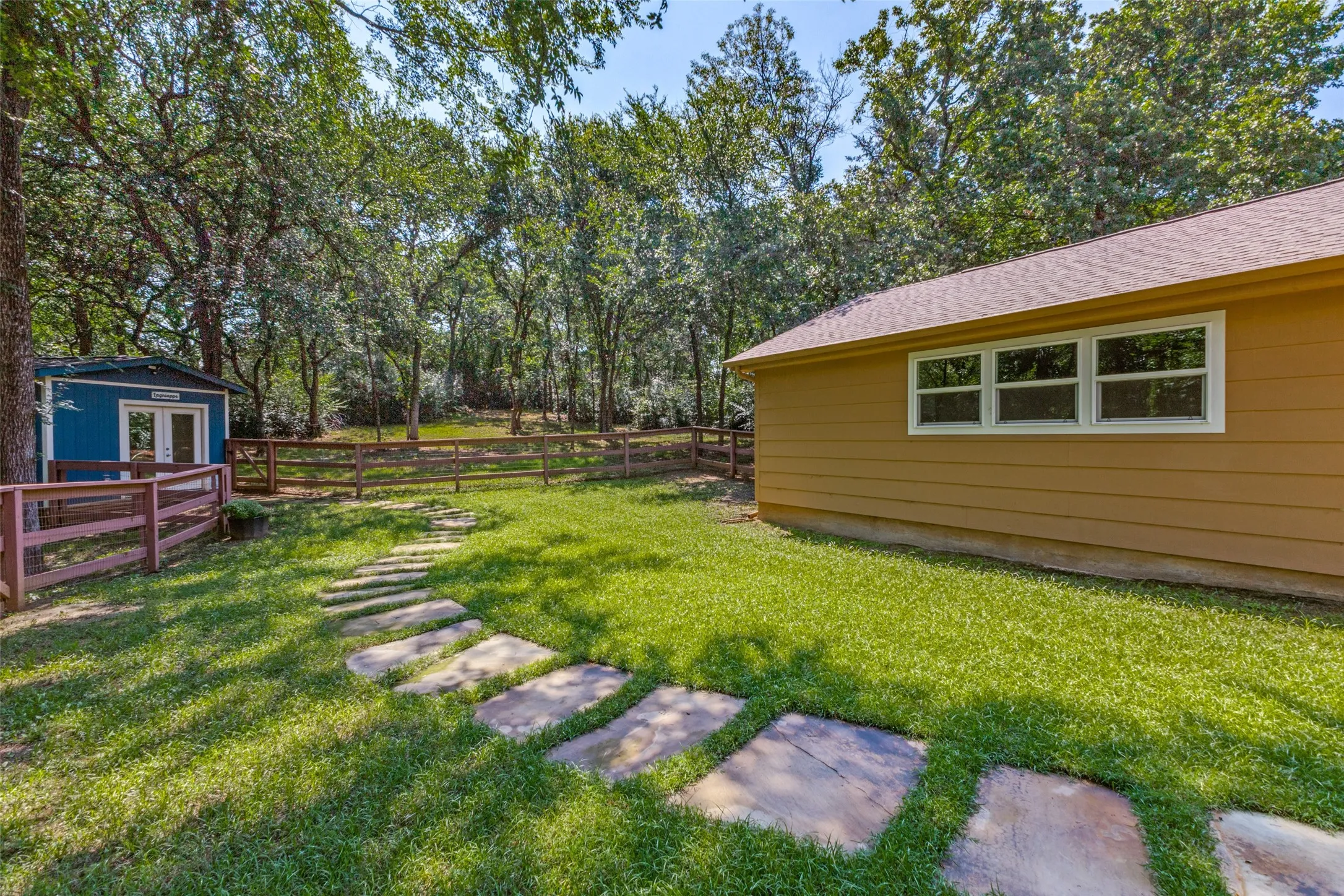 The walkway leads the cutest building that can be an office, den, whatever you need it to be!
