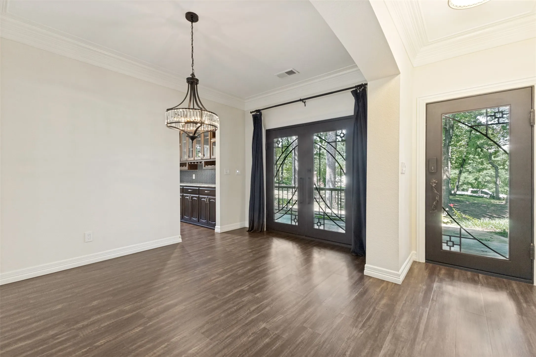 A gorgeous iron front door leads you into this beautiful home.