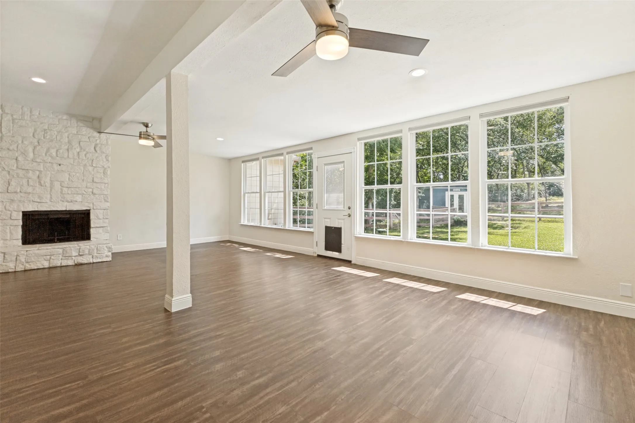 Very spacious family room with a stone floor to ceiling fireplace and awsome views of your park like backyard.