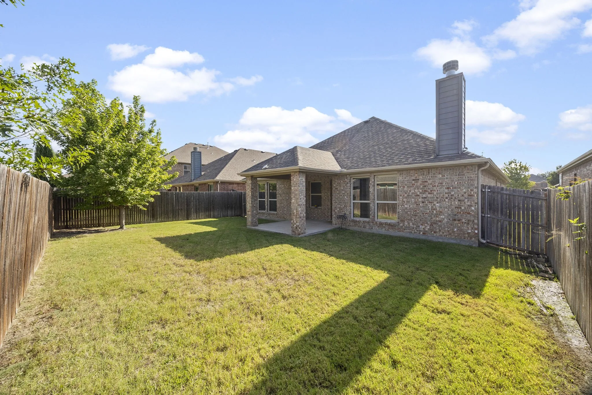 Back view of the house and patio with plenty of room for fun.