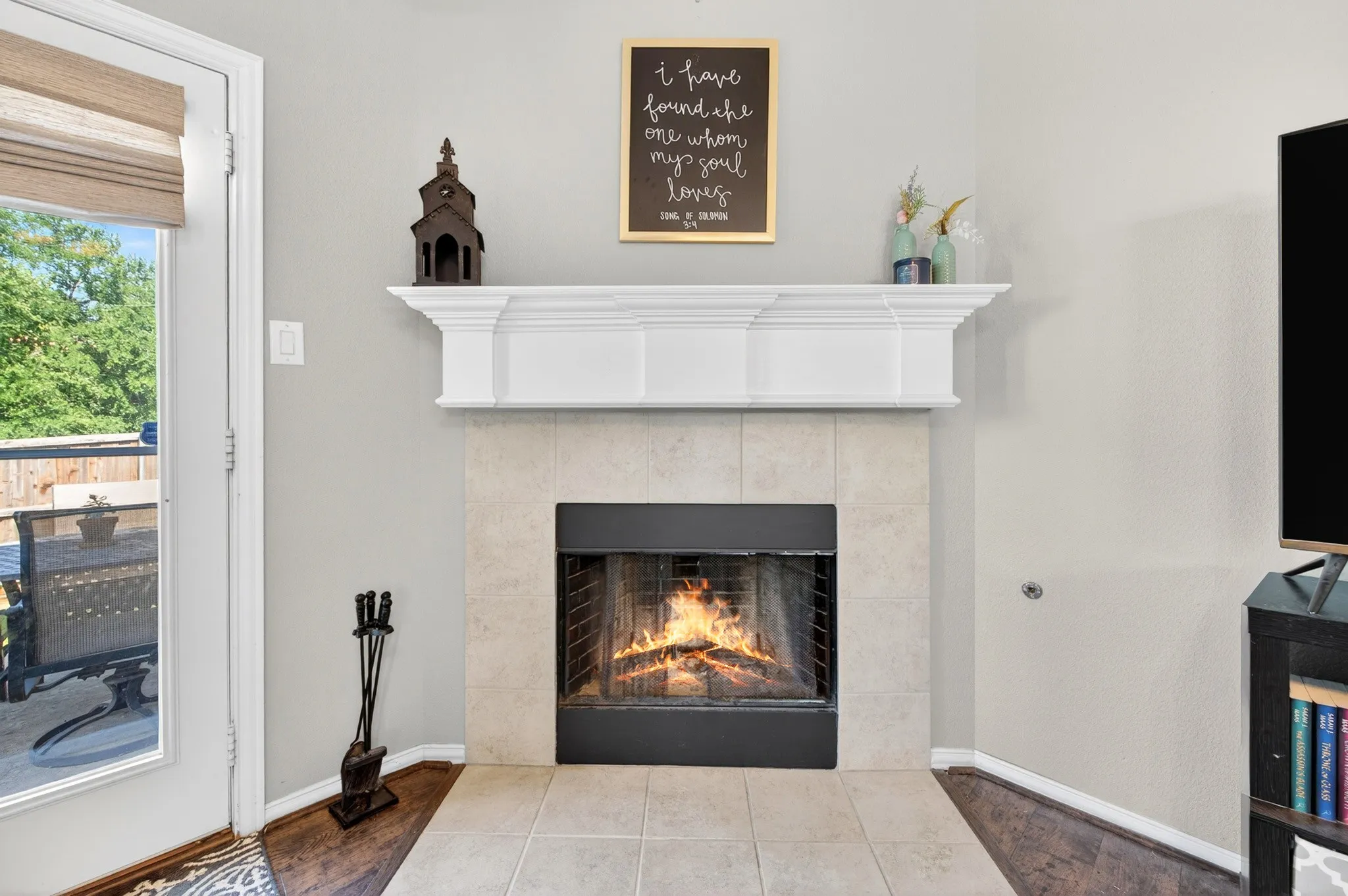 Corner fireplace with a tile surround and a crisp white mantel