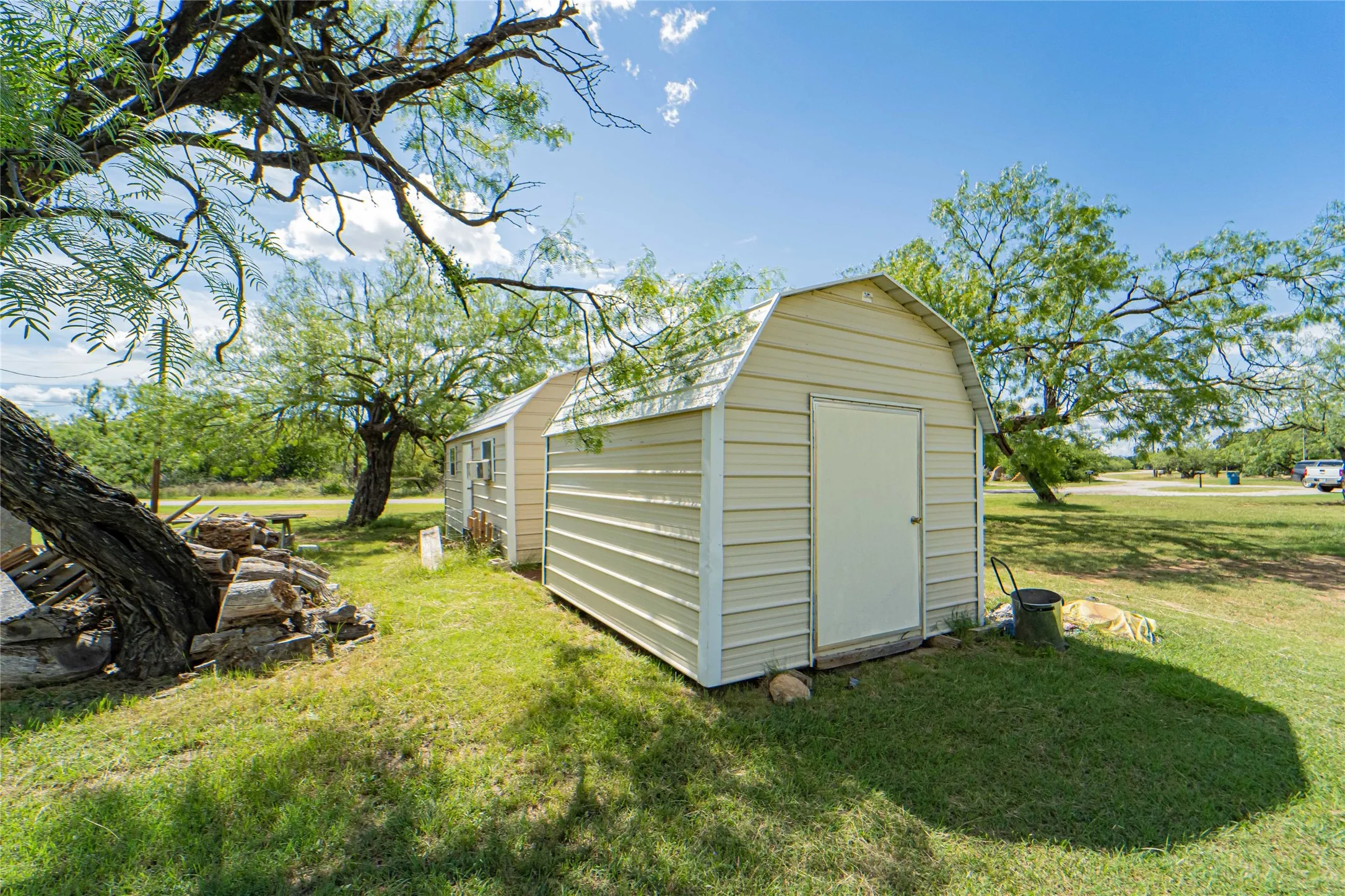 Two detached storage sheds with gambrel roofs