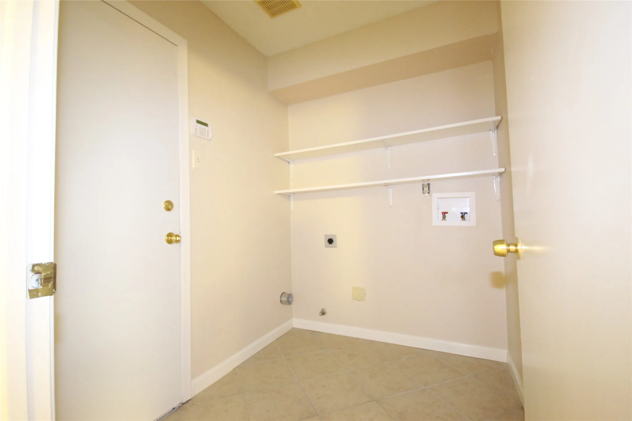 Utility room is off the kitchen with door to garage for convenience.
