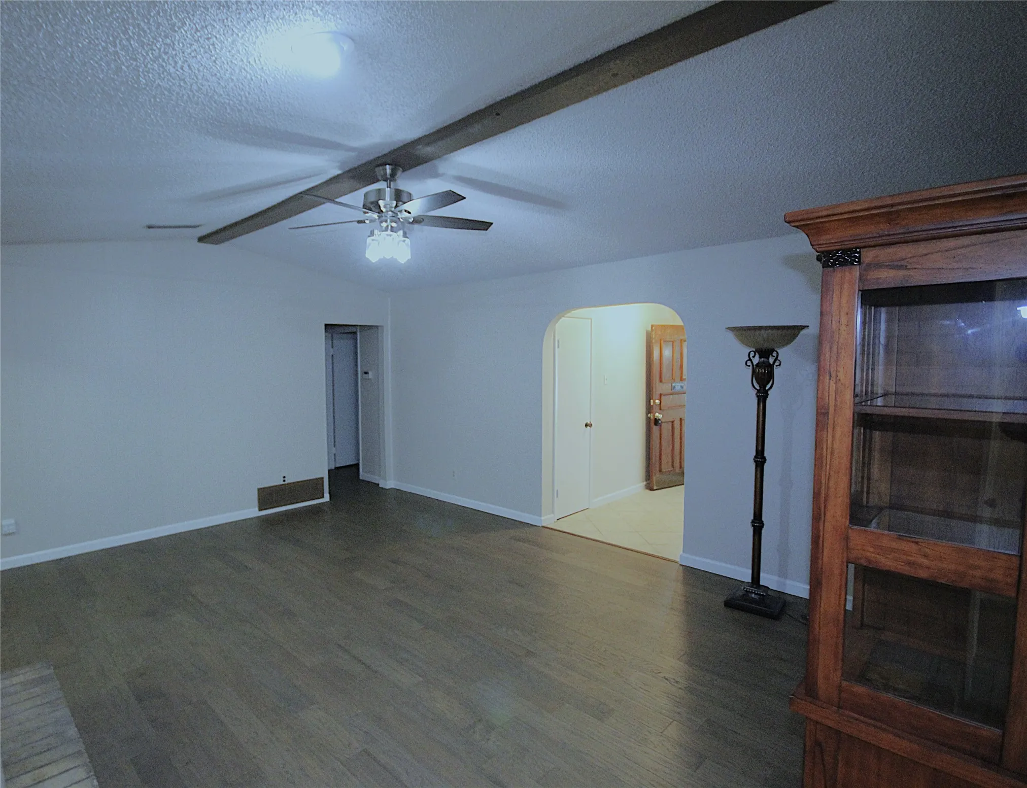 Updates include new paint throughout, engineered wood flooring, beamed ceiling