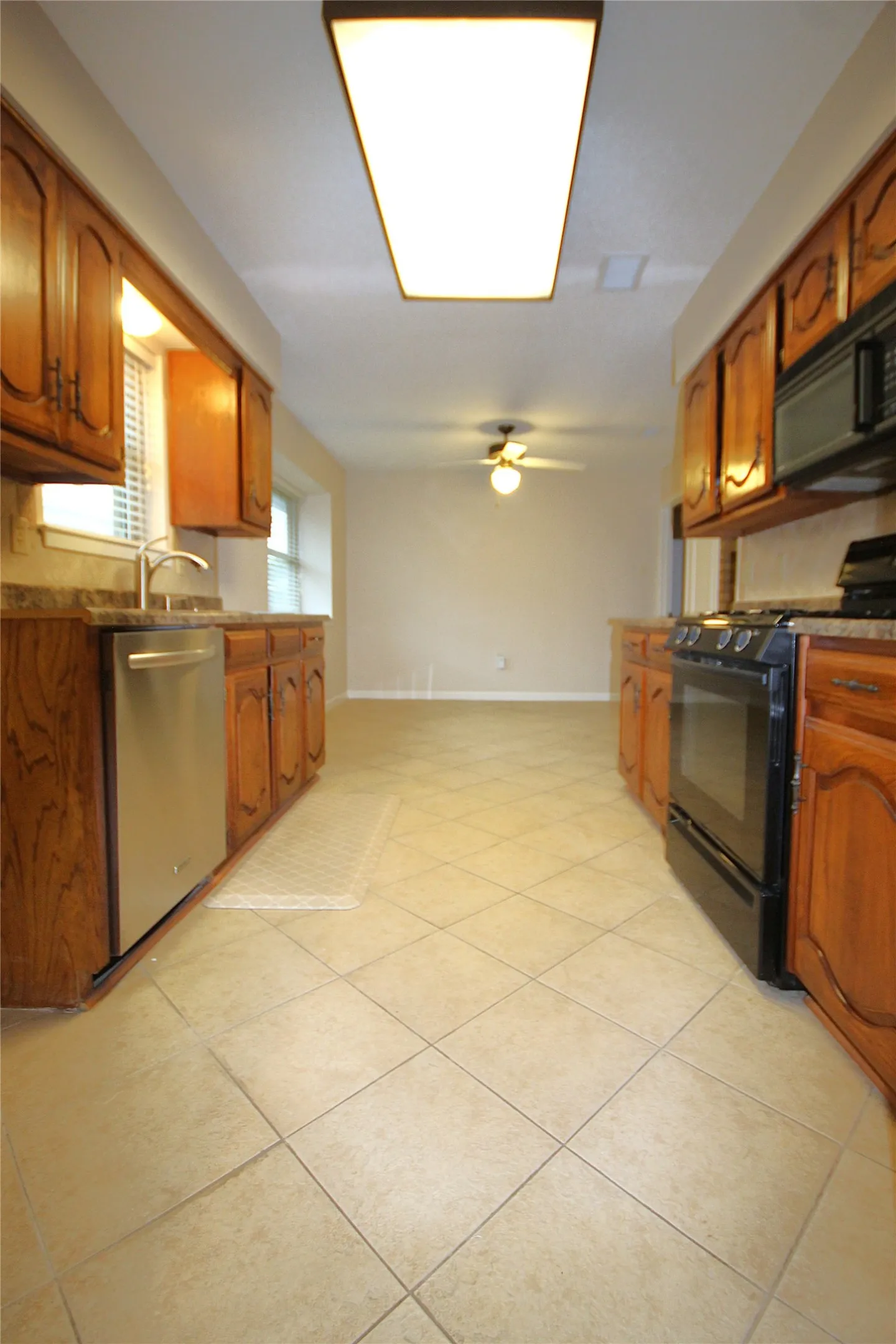 Kitchen offers real wood cabinetry, tiled floor, breakfast nook, updated appliances and a window over the sink to view outside when cooking or cleaning.