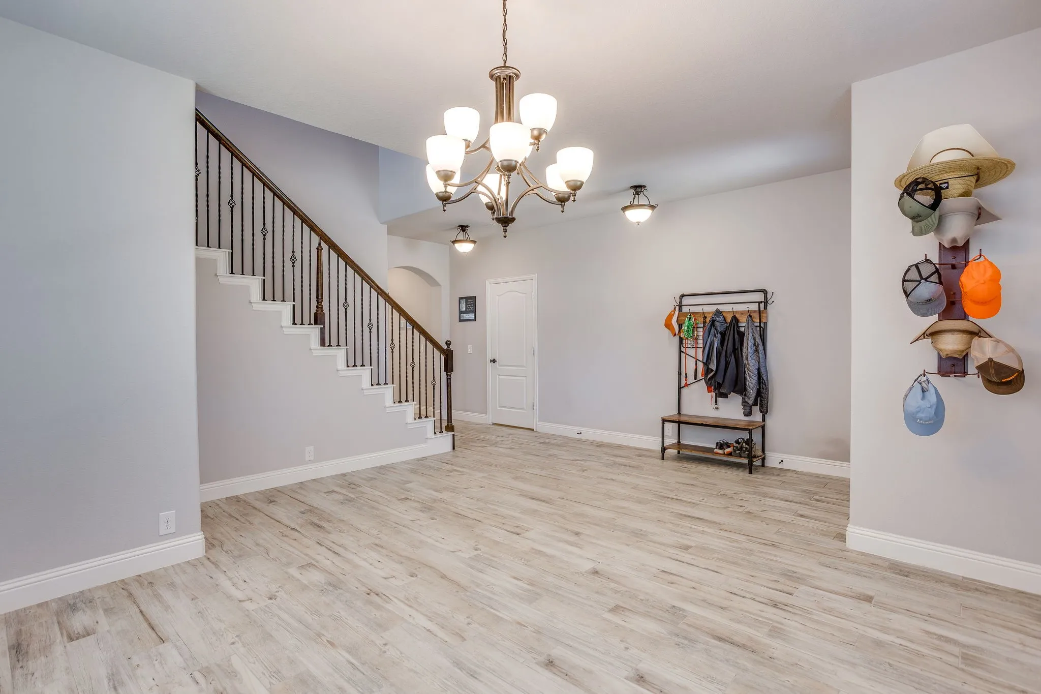 Stairway featuring wood and decorative metal balusters