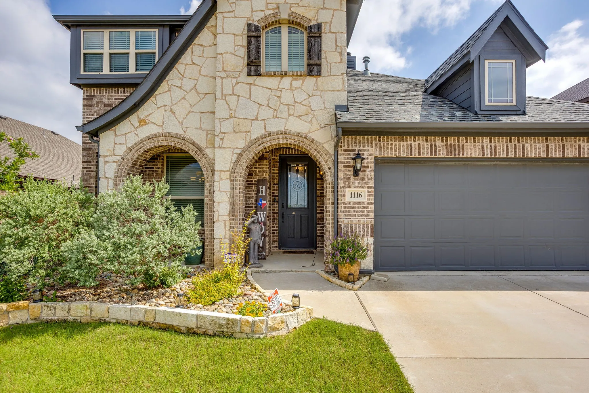 Stone and brick facade featuring arched entryways