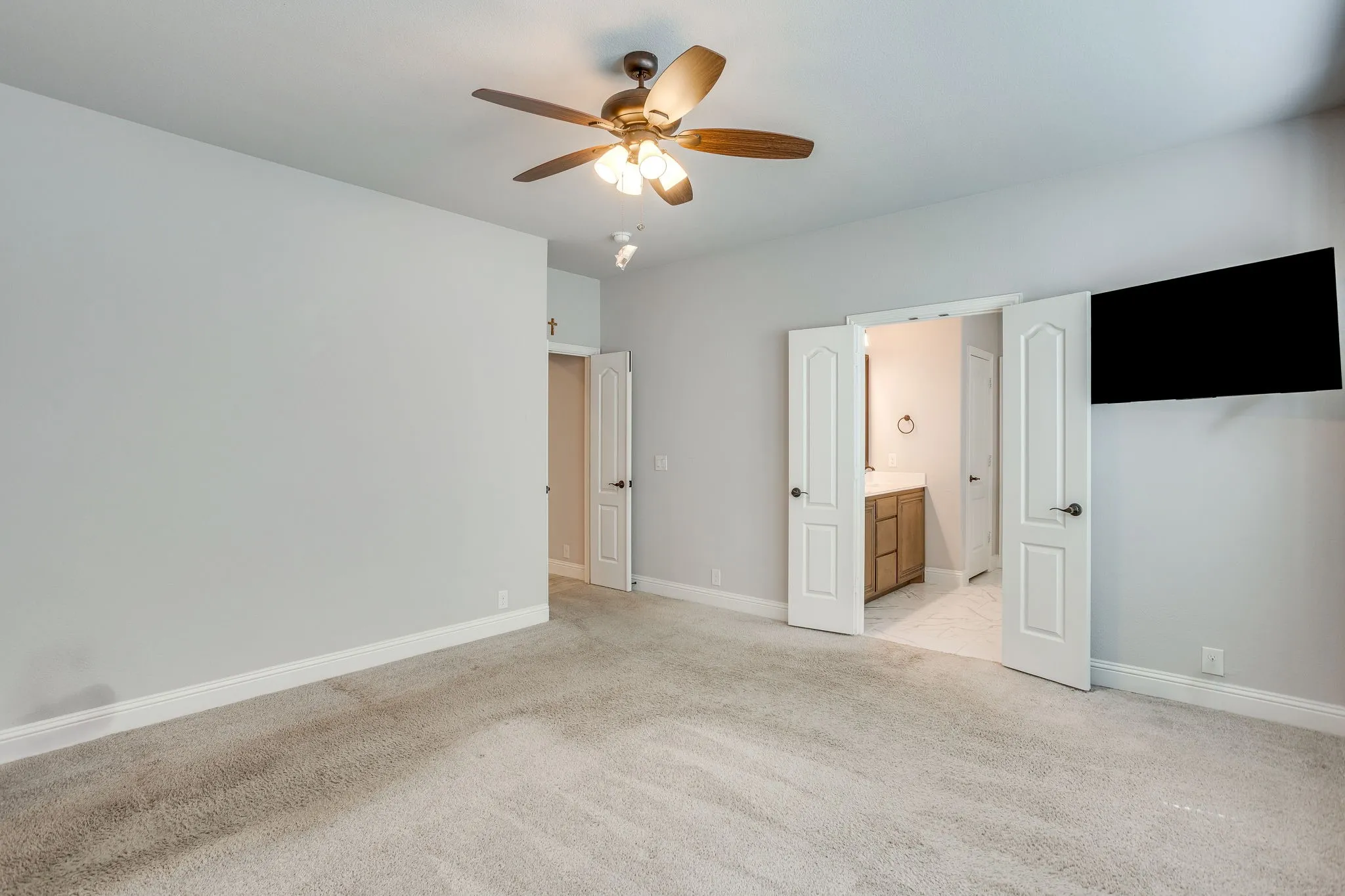 Spacious room featuring neutral carpet and light gray walls