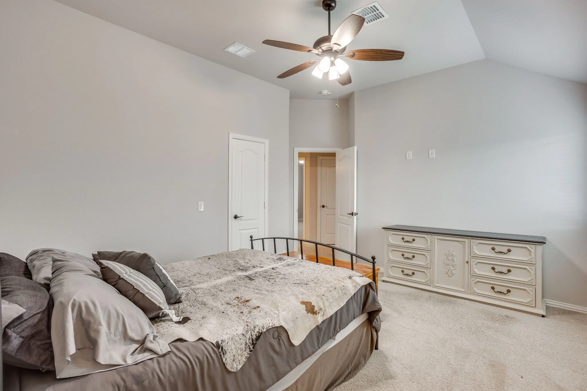 Vaulted ceiling with a flush-mount ceiling fan and integrated lighting
