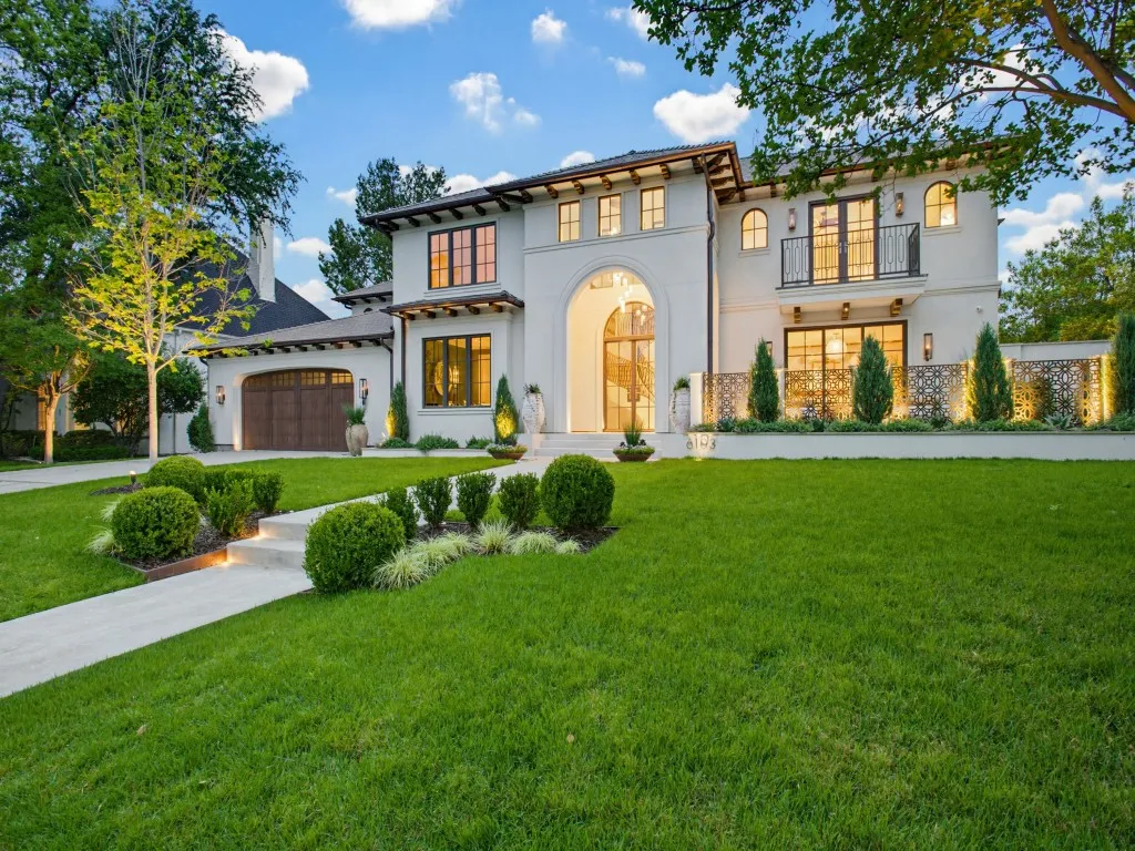 Stucco exterior, wood garage doors and slate roof.