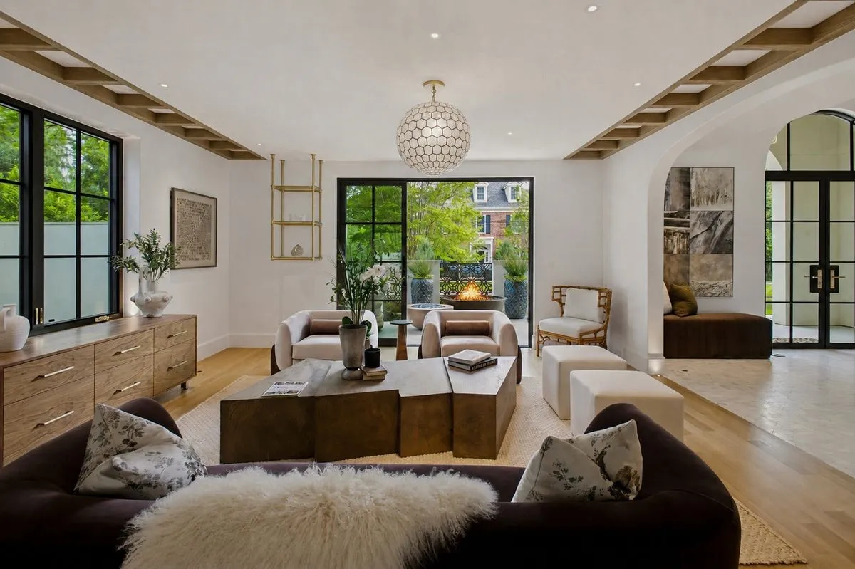 Custom ceiling treatment and lighting as architecture fill the room that spills out into the front courtyard