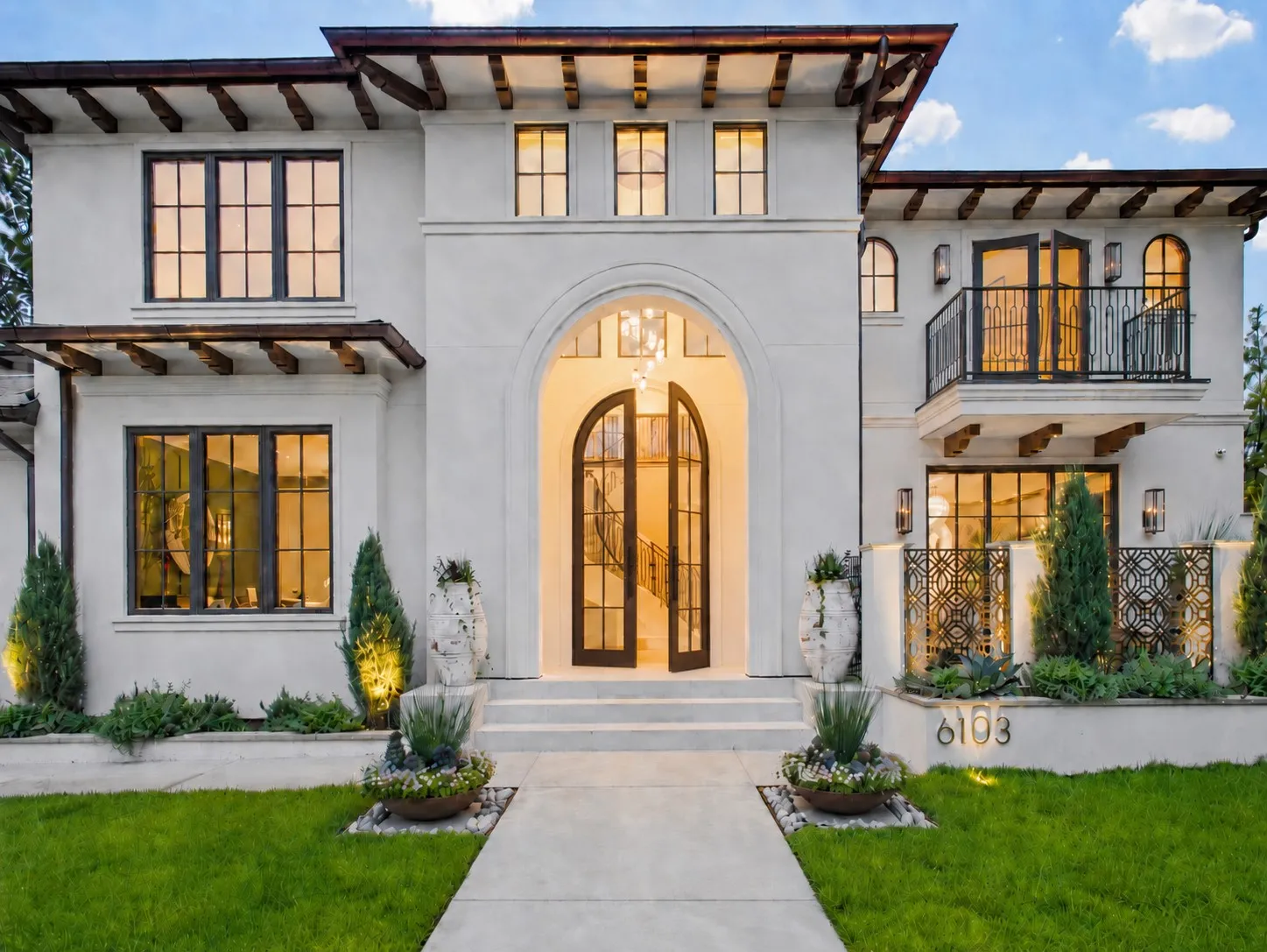 A modern Mediterranean masterpiece featuring private front courtyard flanked by gas lamps and beautiful 2nd floor primary suite balcony with gas lamps!