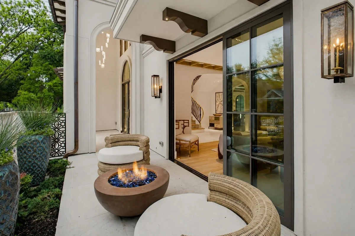 Front courtyard featuring gas lamps and a gas fireplace