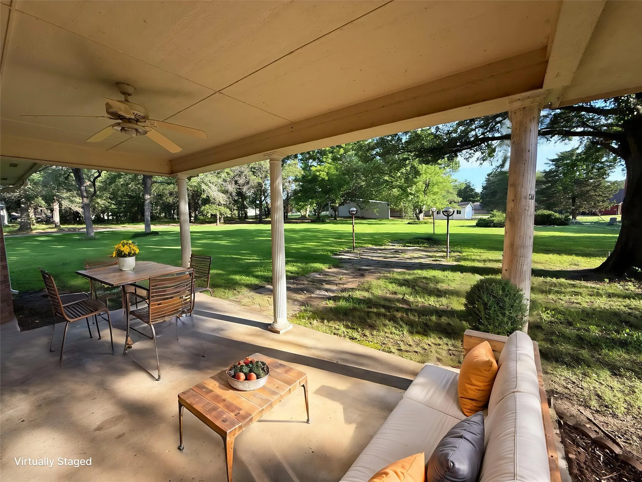 Covered concrete patio with ceiling fan