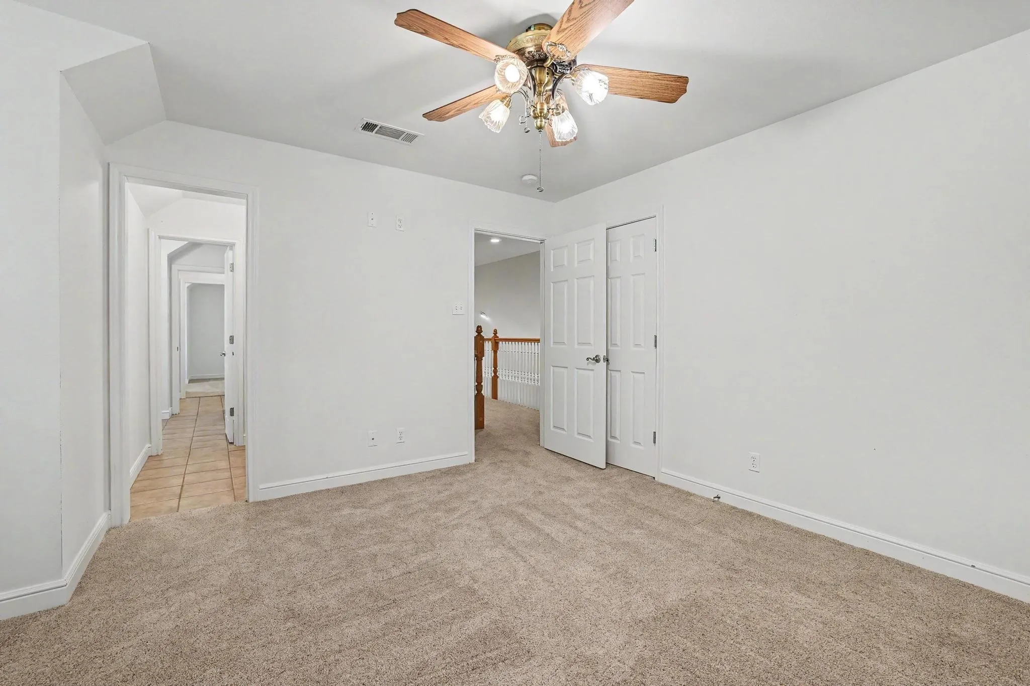 Previous bedroom featuring a ceiling fan with light fixture, white walls, white trim, looking towards the Jack and Jill bath.