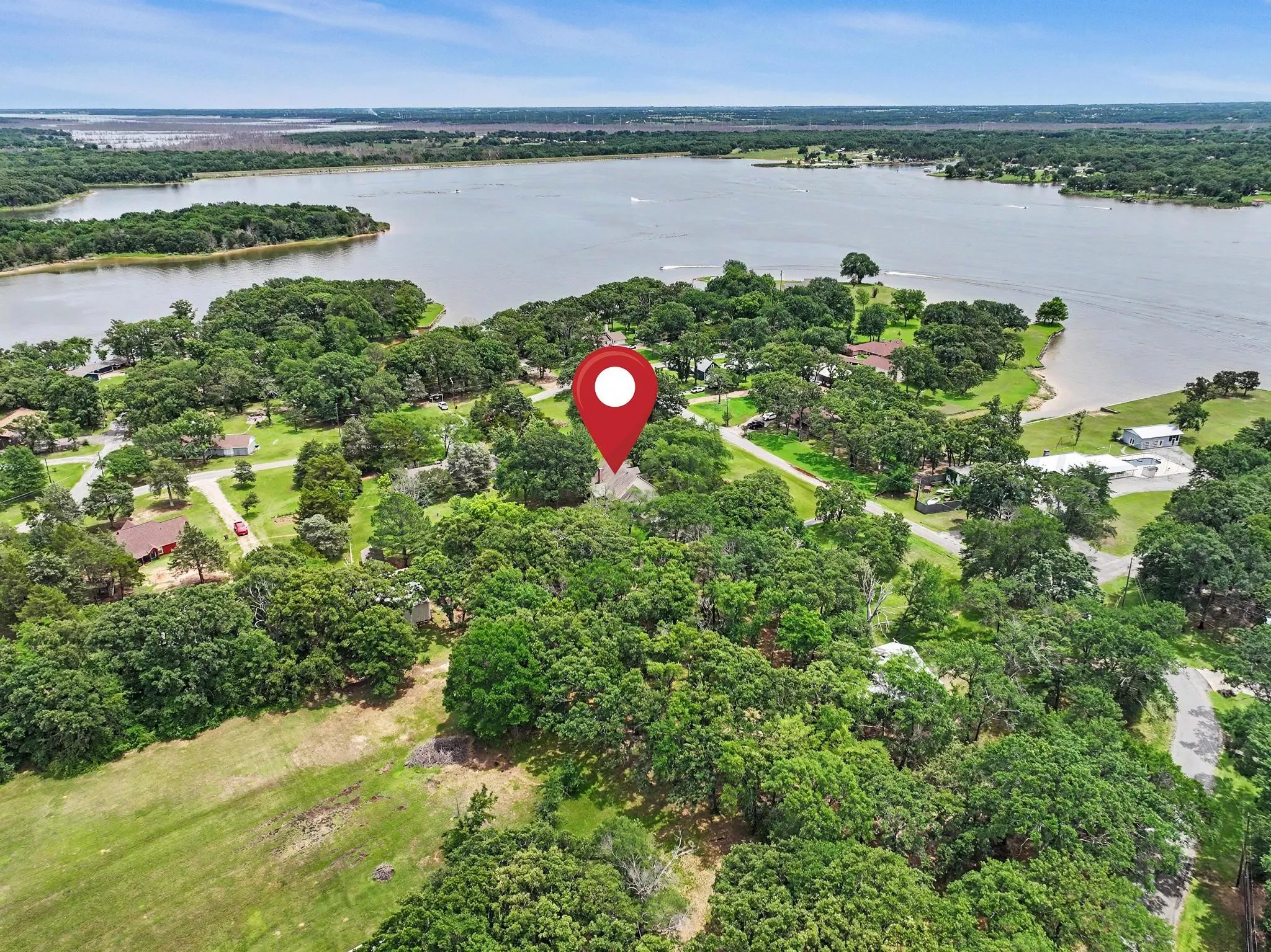 Lakeside community with extensive tree cover. Lake Bois 'D Arc is seen at the top left of this photo.