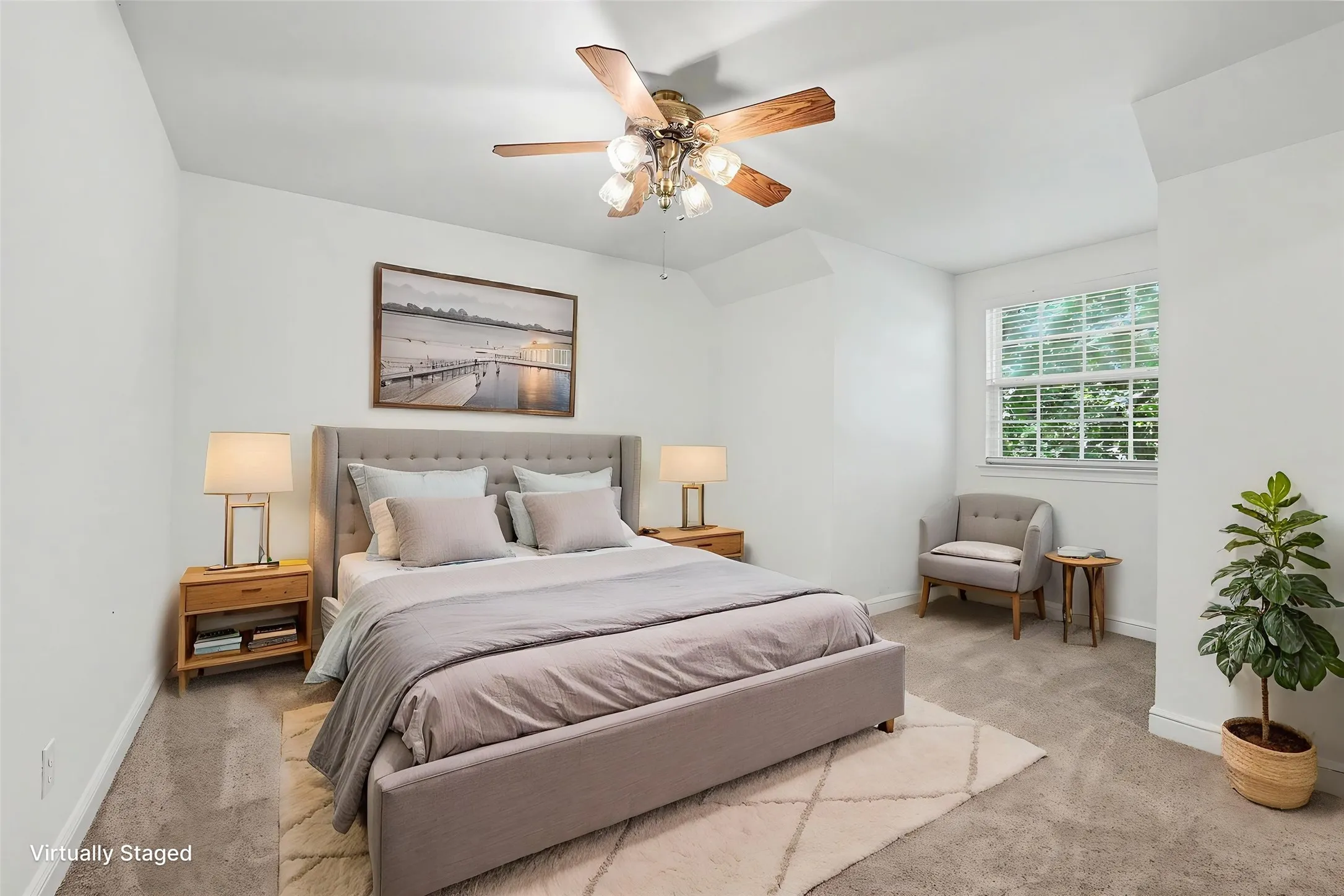 Upstairs carpeted bedroom with a window featuring horizontal blinds, white walls, and a ceiling fan with light fixture.