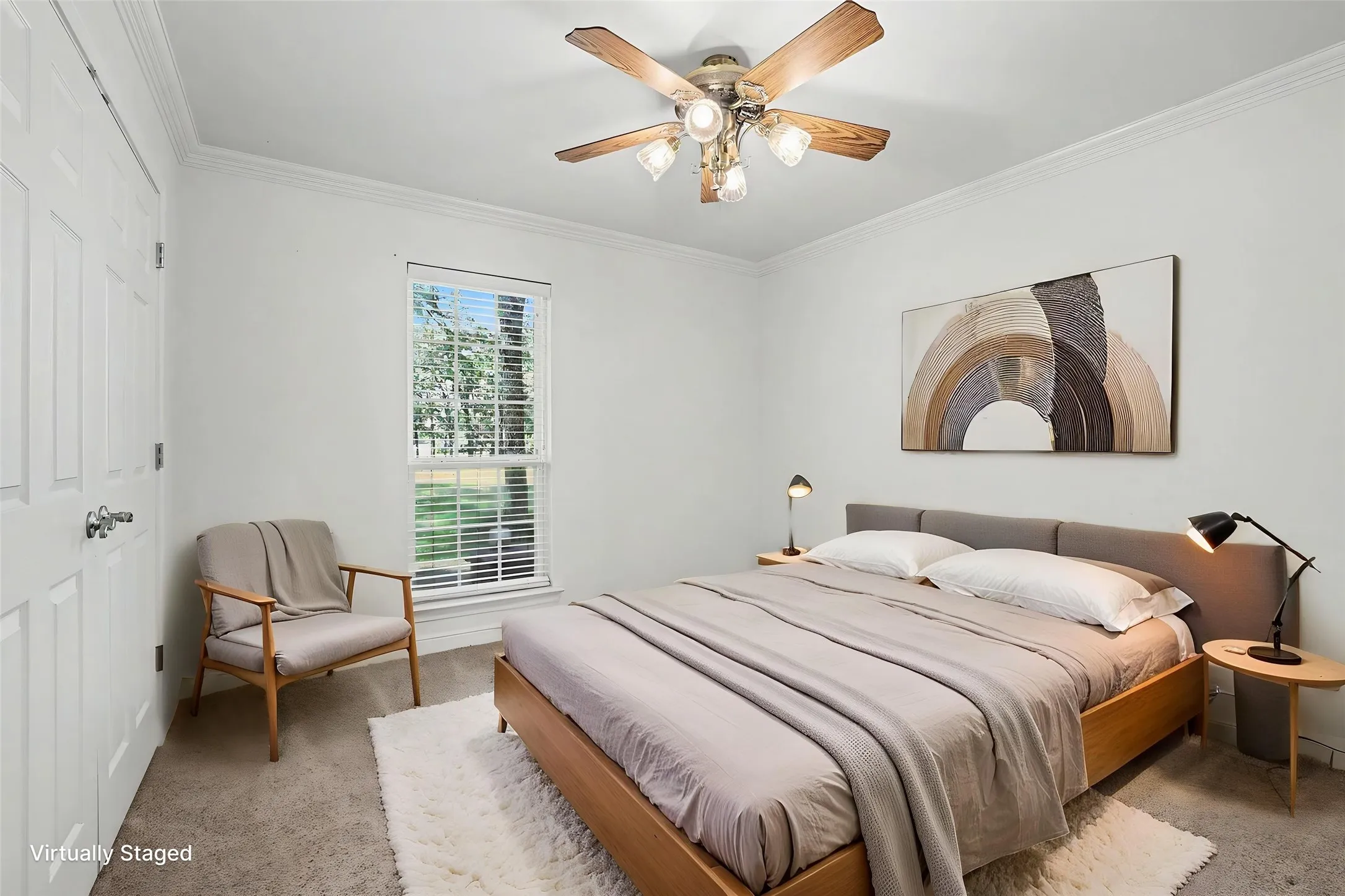 Downstairs bedroom featuring a multi-pane window with blinds, crown molding, and a ceiling fan with light fixture.