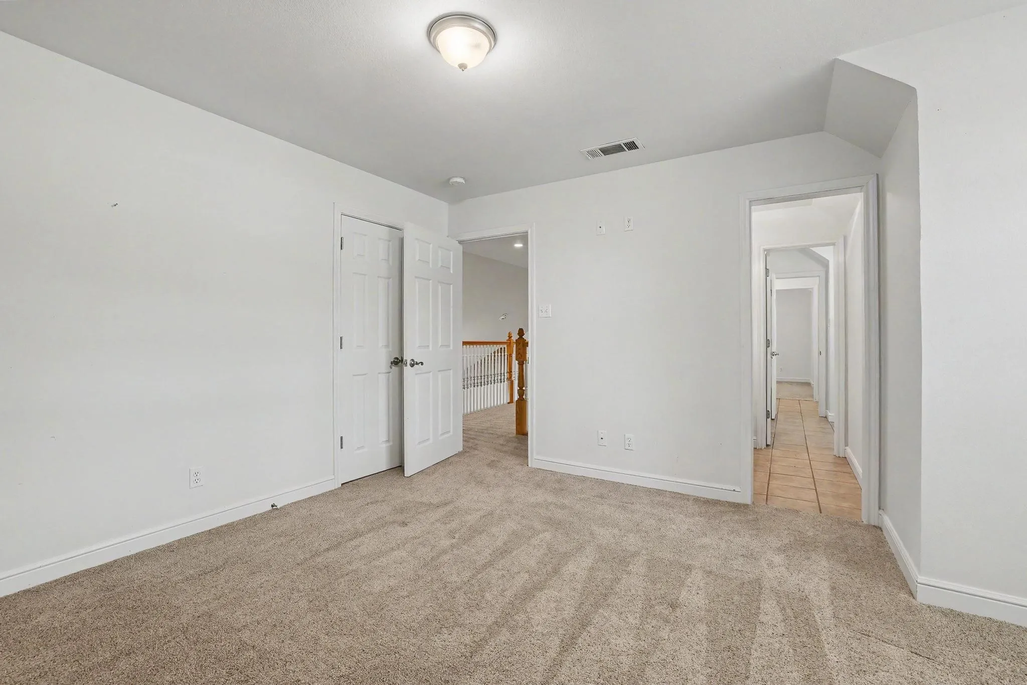Looking towards Jack and Jill bath and open-air hallway that overlooks the den.
