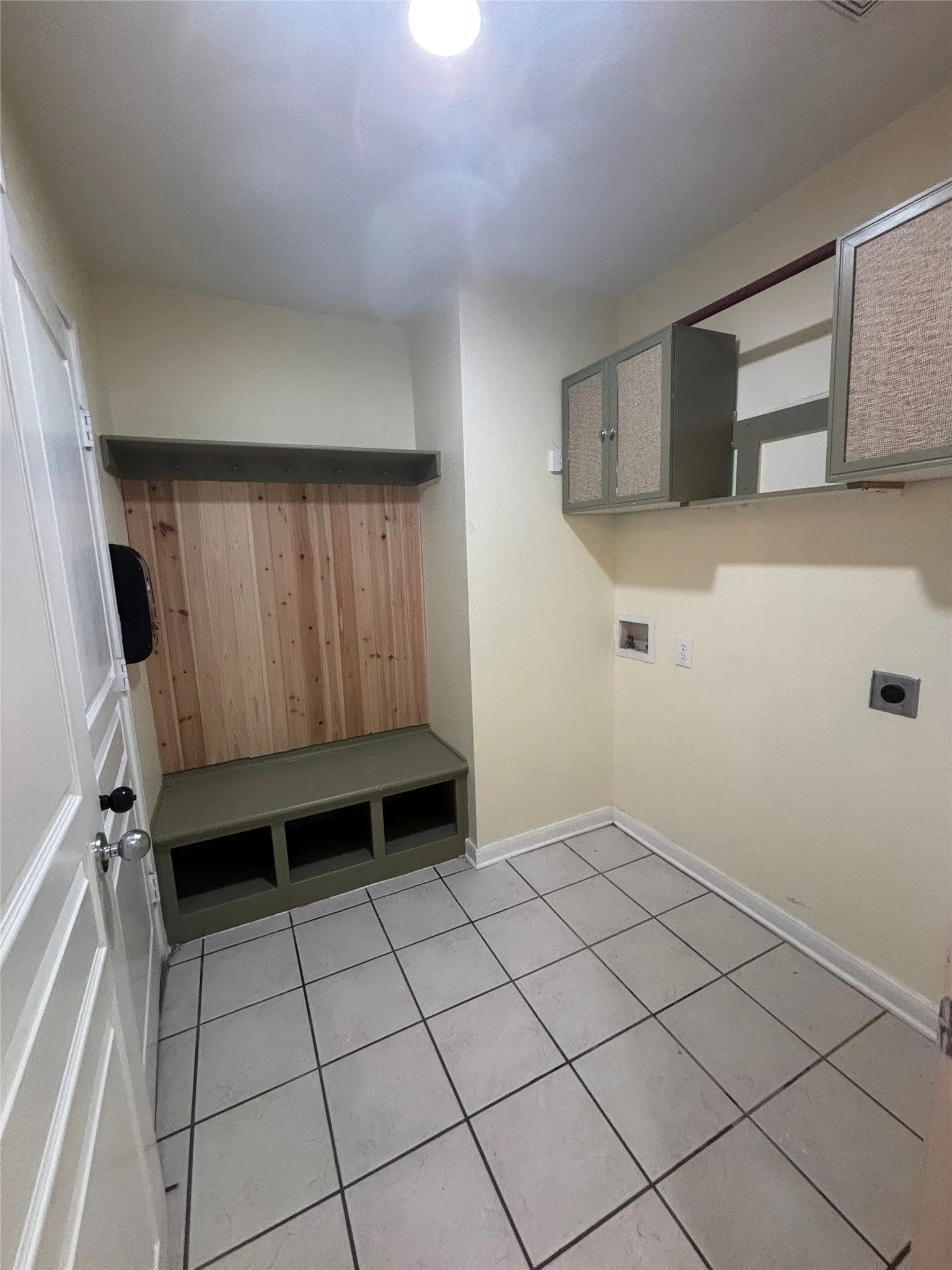 Dedicated utility space featuring tile flooring